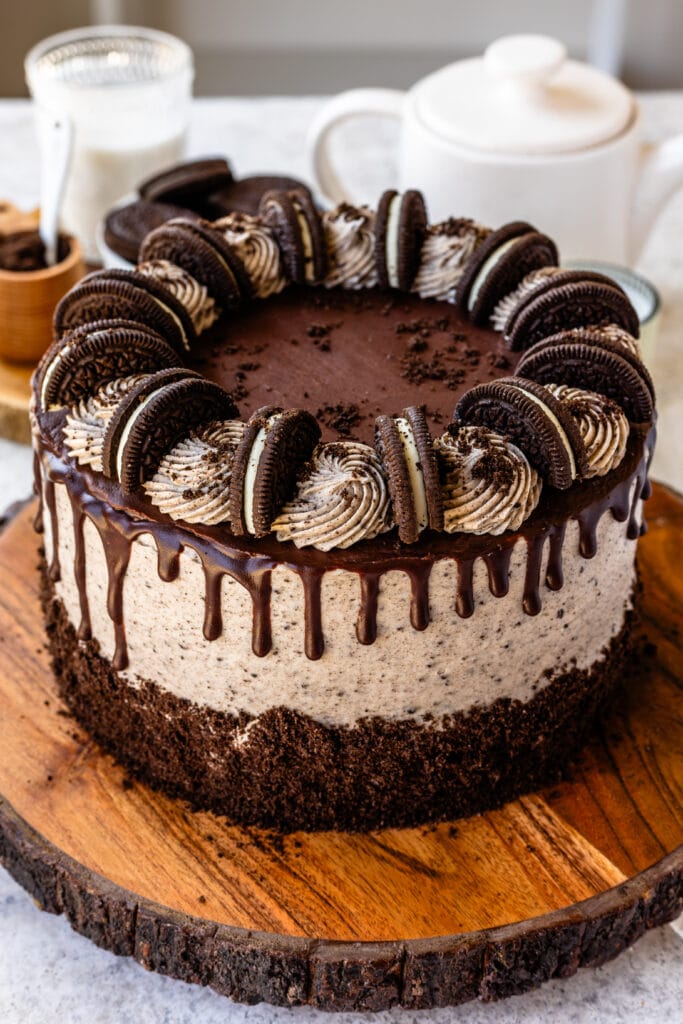 cookies and cream cake with ganache drip on top, and oreo cookies.