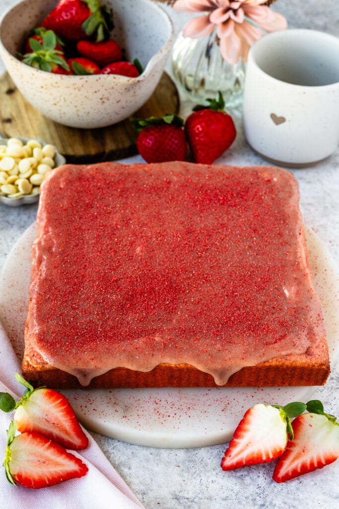 Strawberry Brownies with strawberry ganache on top and sprinkled freeze dried strawberry powder on top.