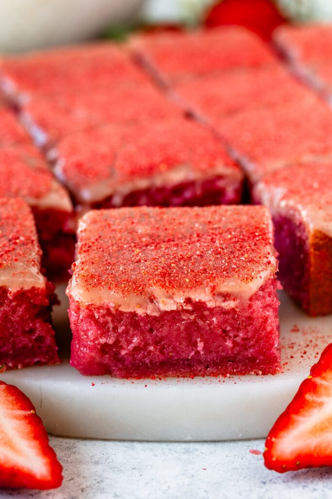 strawberry brownie sliced on top of a plate.