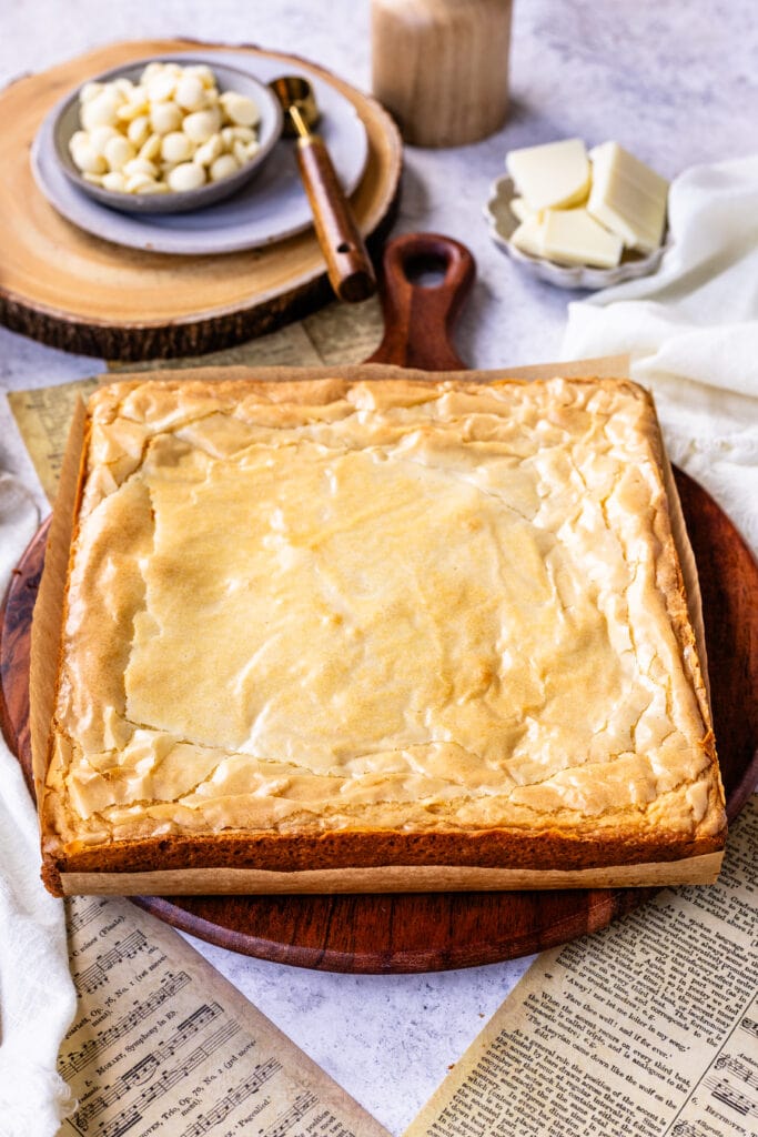 white brownie batter baked on top of a wooden board.