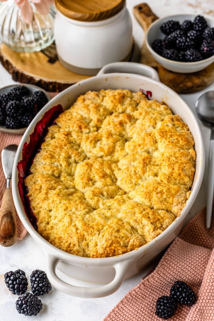 blackberry cobbler in an oval baking dish.