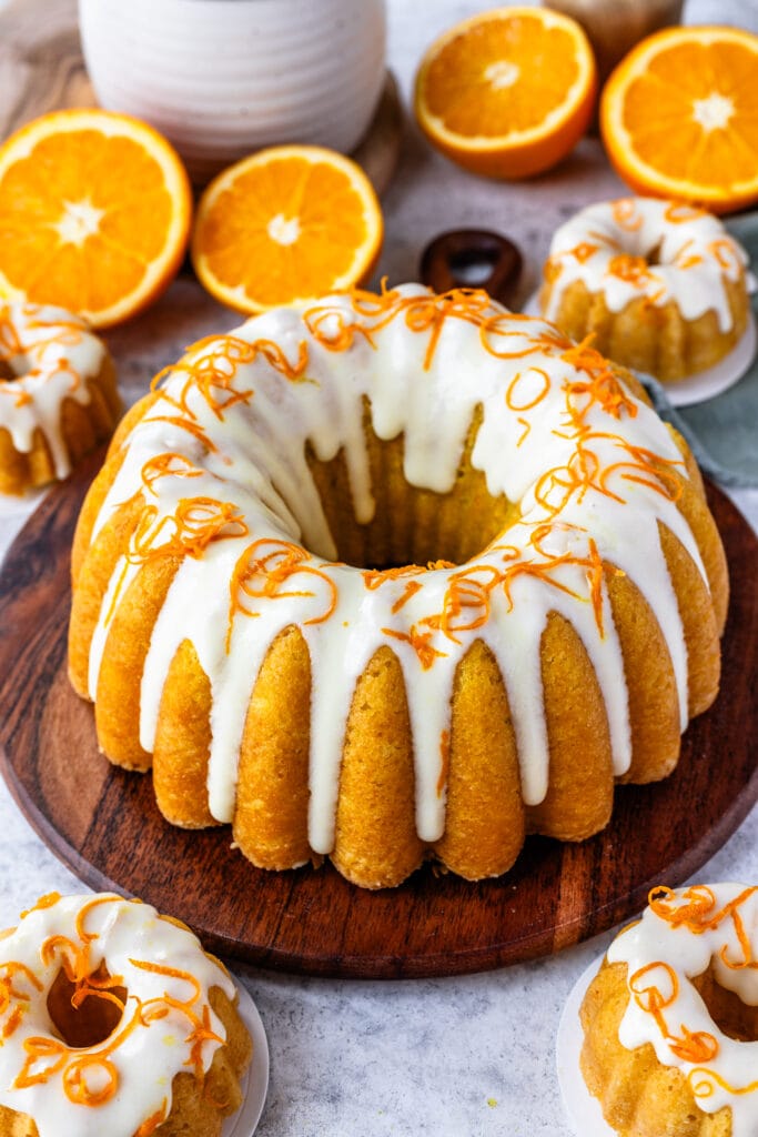 Orange cake with cream cheese glaze on top, and orange zest.