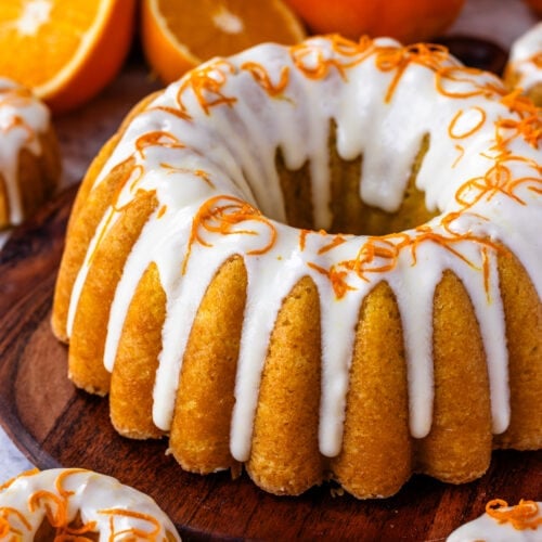 Orange cake with cream cheese glaze on top, and orange zest.