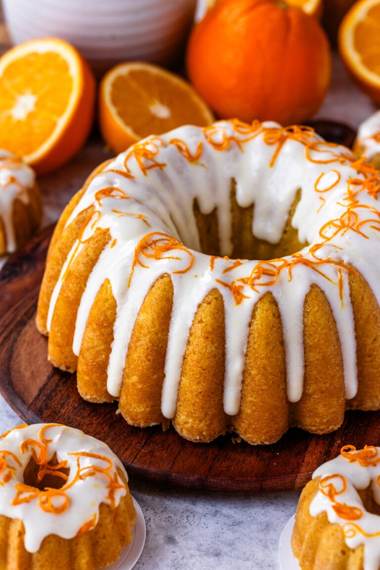 Orange cake with cream cheese glaze on top, and orange zest.