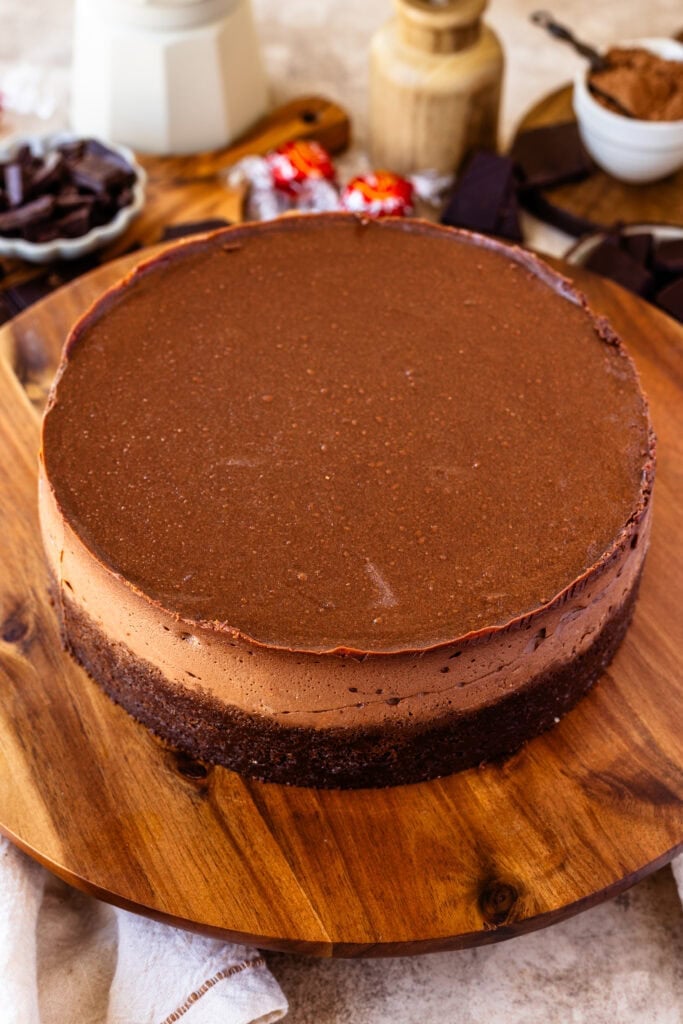 chocolate cheesecake on top of a wooden board.