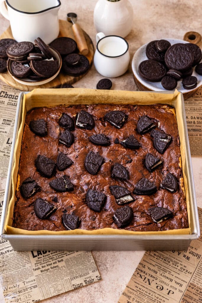 oreo brownies baked in a 8x8 pan with oreos on top.