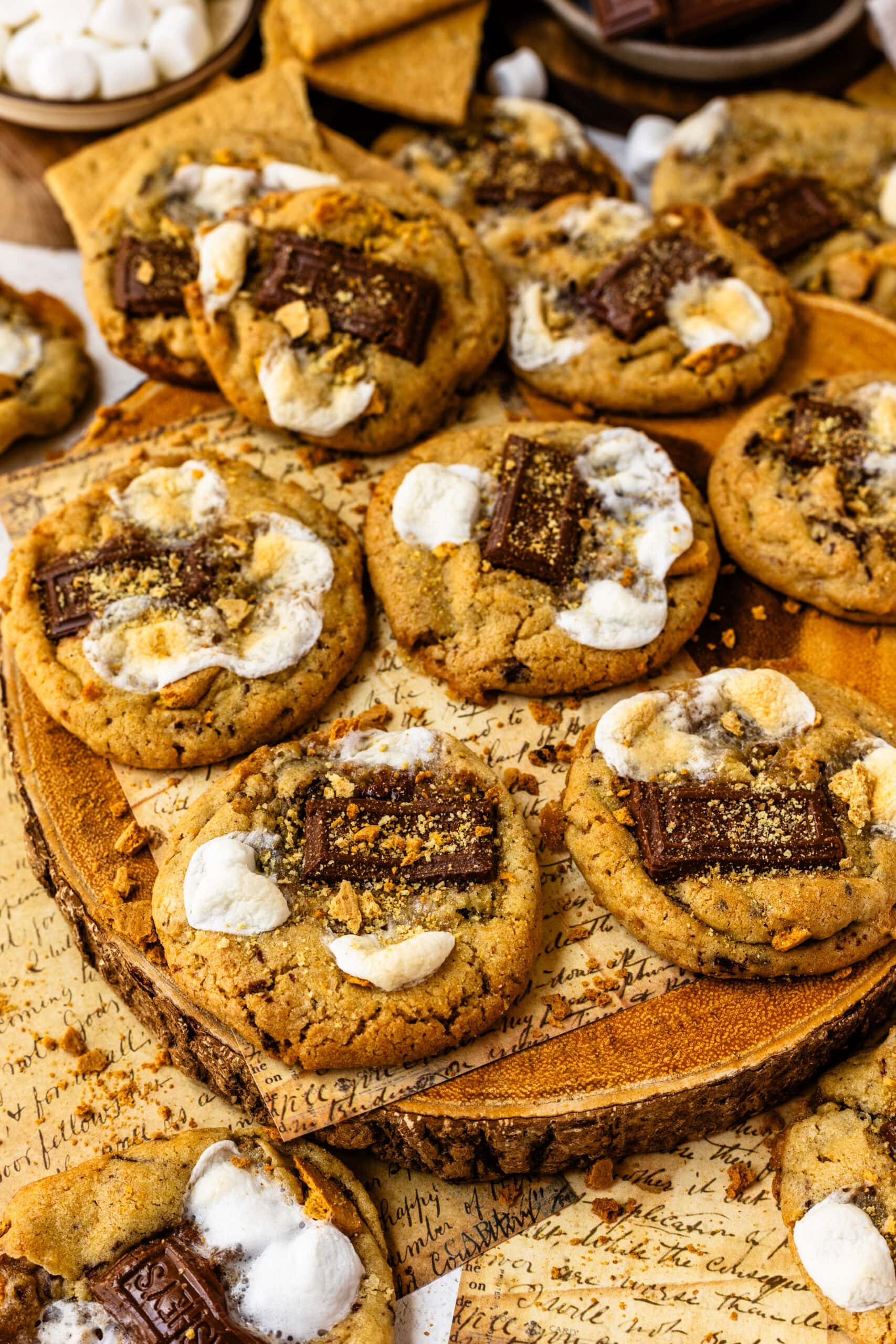 S'mores cookies with pieces of chocolate, toasted marshmallows, and graham crackers.