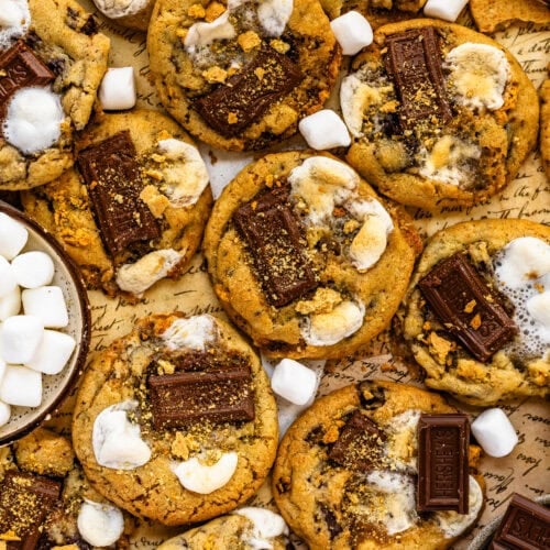 S'mores cookies with pieces of chocolate, toasted marshmallows, and graham crackers.