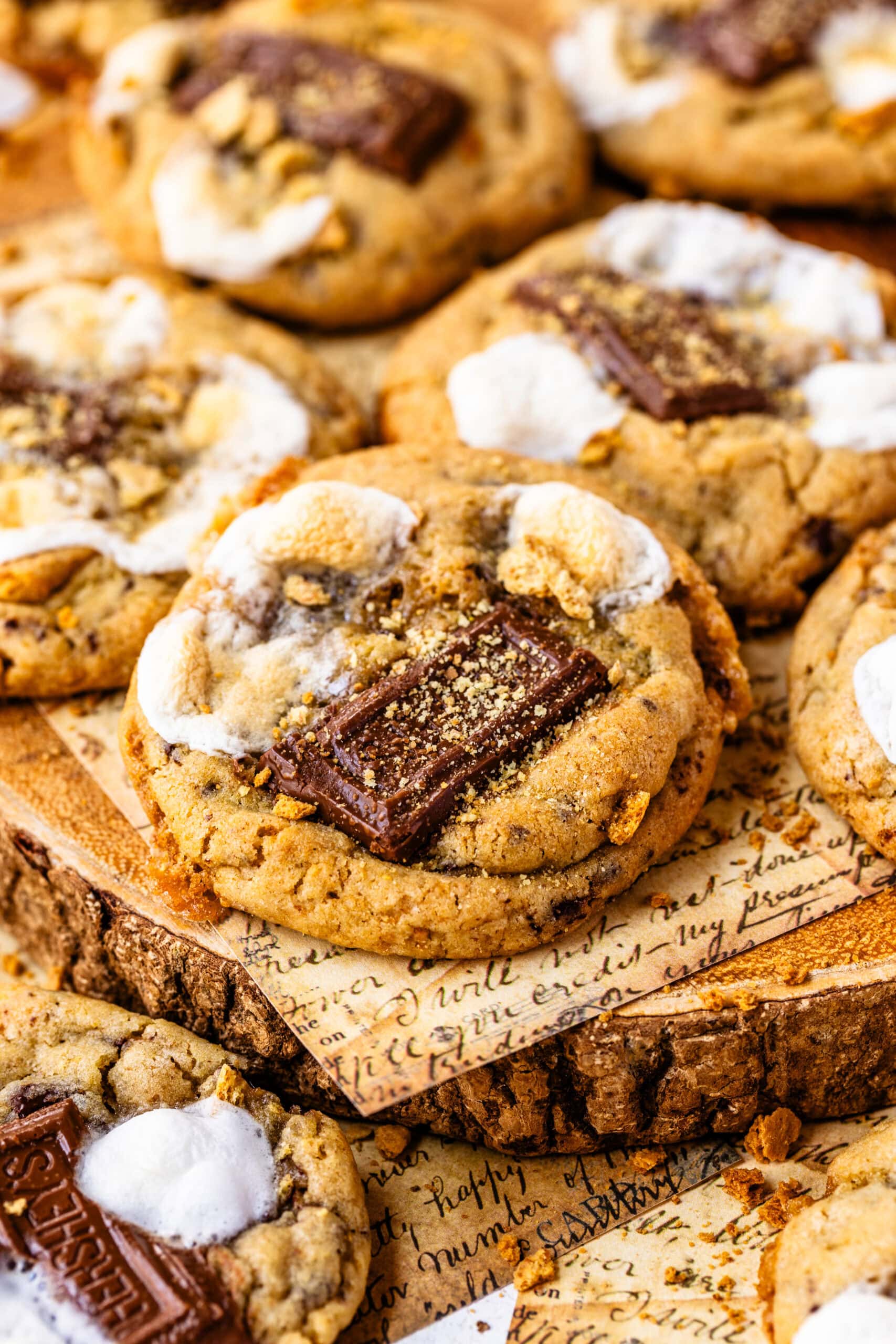 S'mores cookies with pieces of chocolate, toasted marshmallows, and graham crackers.