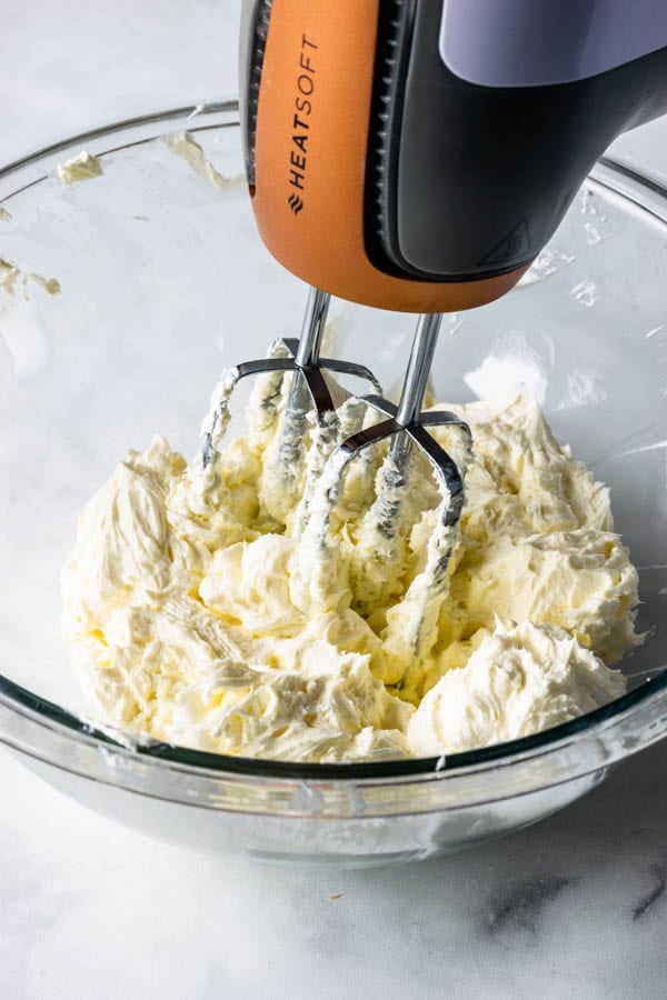 beating cream cheese with an electric mixer.