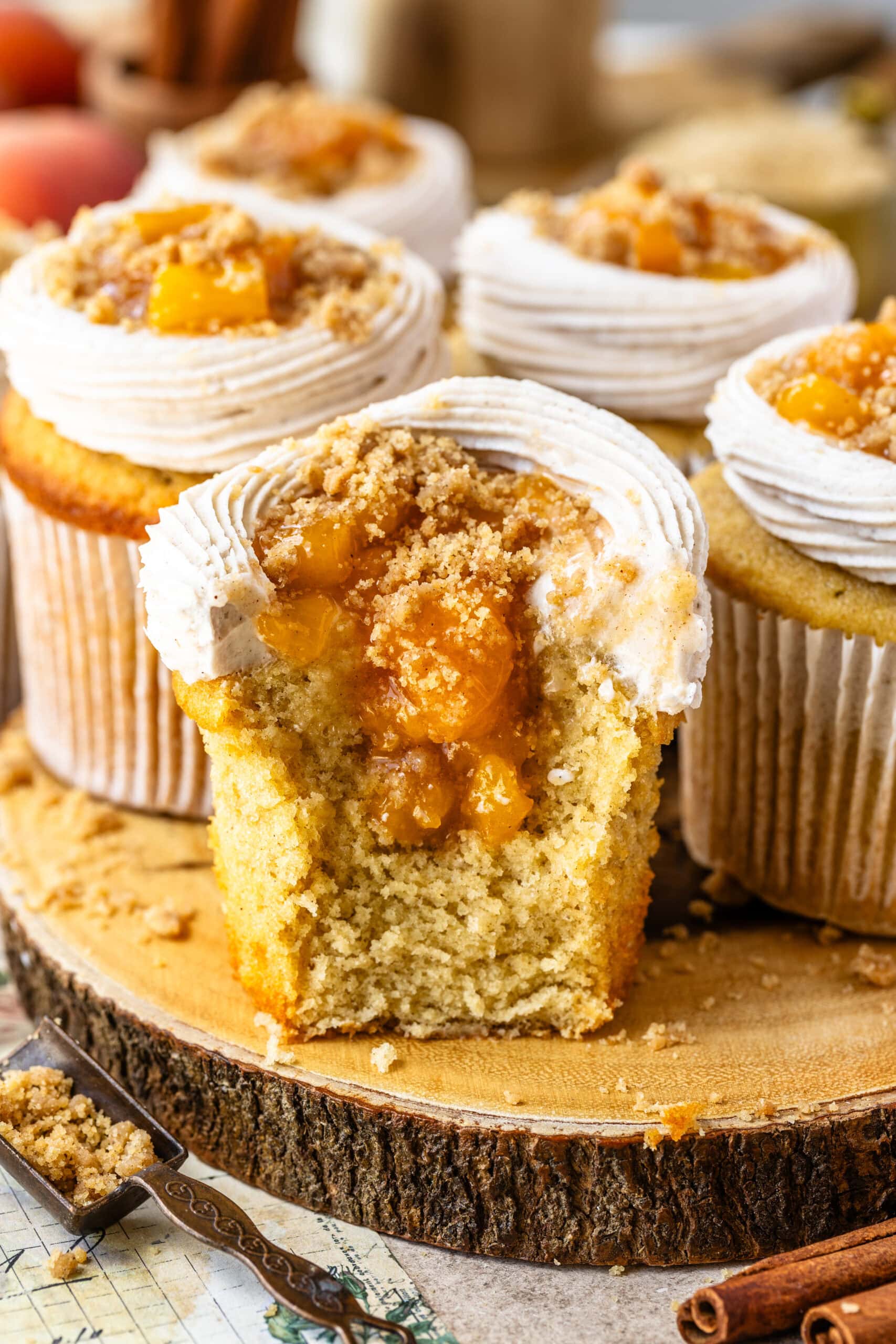 peach cupcakes filled with peaches, sliced in half showing the peach filling inside.