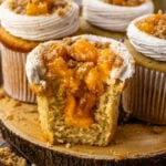 peach cupcakes filled with peaches, sliced in half showing the peach filling inside.