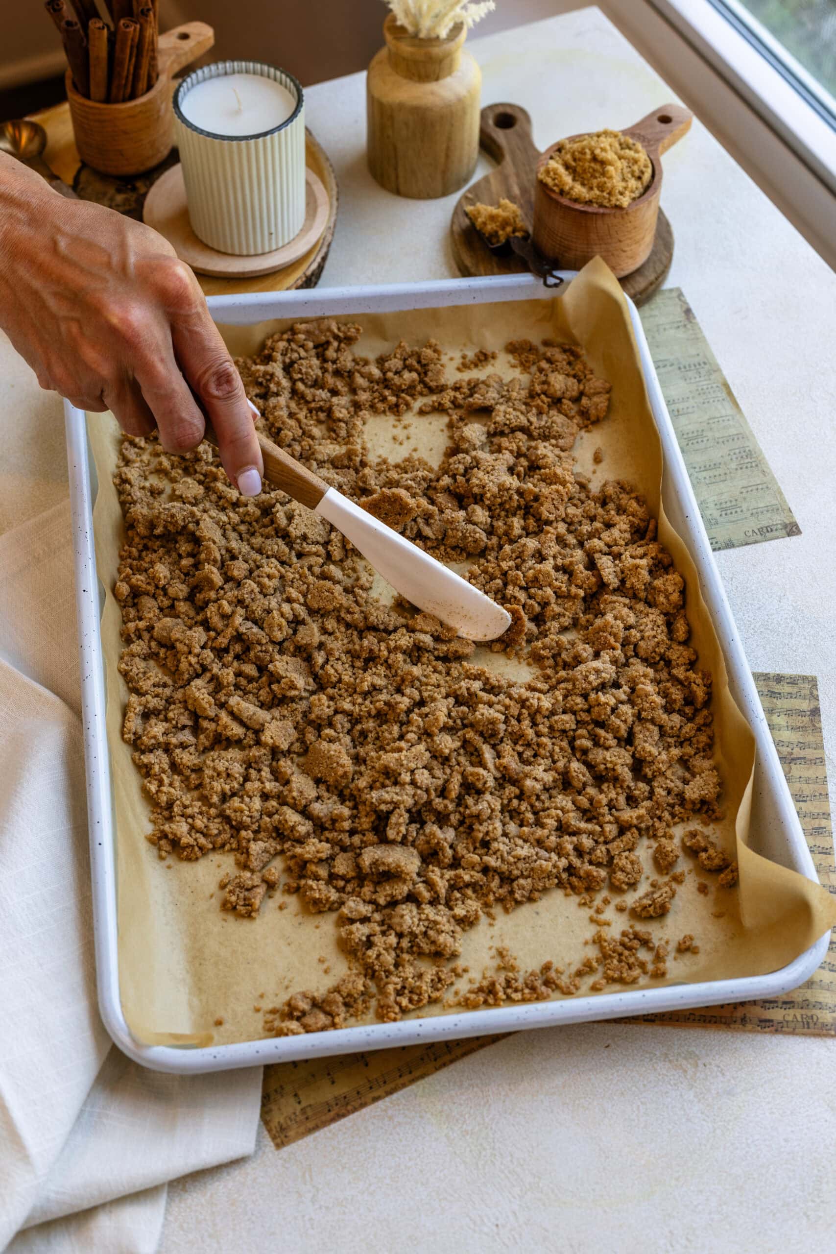 breaking crumbs in a tray with a spatula.