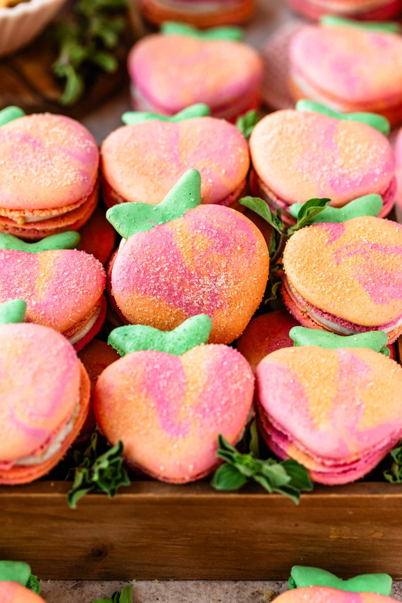 peach macarons in a box.