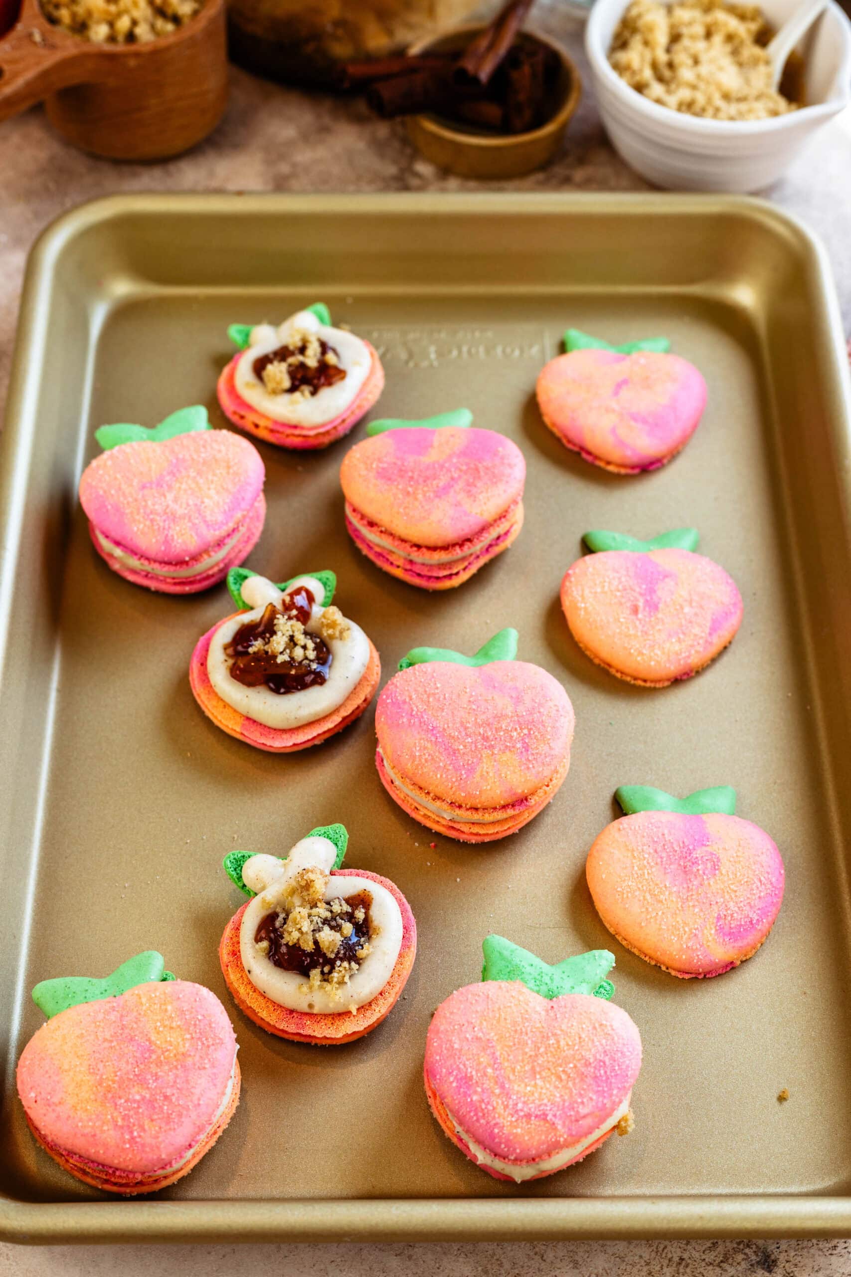first picture: peach shaped macarons with cream cheese frosting piped around the edges, filled with peach jam and streusel crumb.