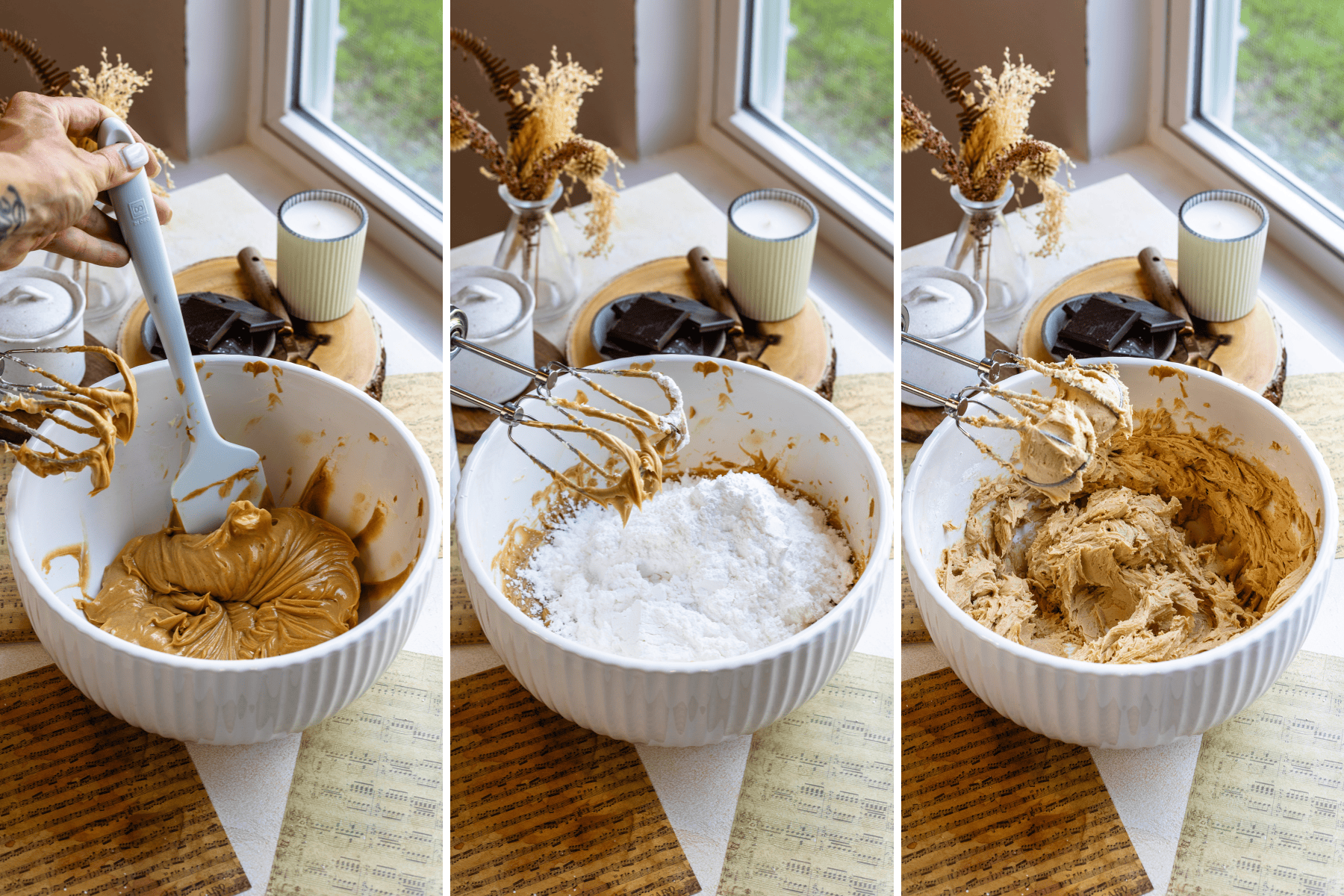 Mixing Peanut Butter Frosting Ingredients: A collage of three images showing different stages of mixing peanut butter frosting. The first image on the left shows a hand holding a spatula, mixing the peanut butter and butter mixture in a large white bowl. The second image in the middle captures powdered sugar being added to the mixture, with the hand mixer resting on the side of the bowl. The third image on the right shows the hand mixer blending the peanut butter frosting until it becomes smooth and fluffy. The scene is set by a window, with a vase of dried flowers, a lit candle, and a plate of chocolate pieces in the background, creating a warm and inviting kitchen atmosphere.