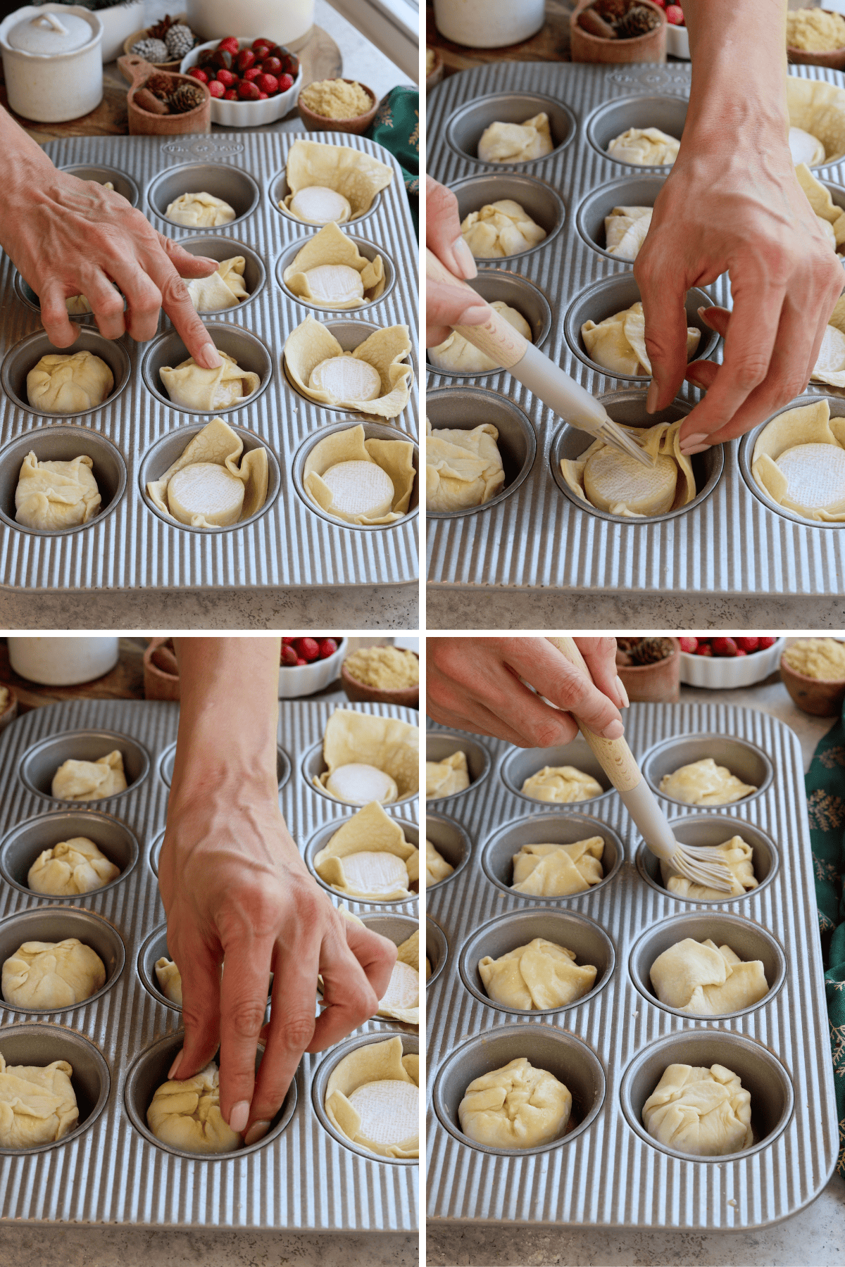 This panel with four images shows the next steps in preparing mini baked brie appetizers. In the first image, hands are folding the edges of the puff pastry over the brie in each muffin tin cup. In the second image, a brush is being used to apply an egg wash to the tops of the wrapped brie, ensuring a golden finish. The third image shows hands gently pressing the pastry to secure it in place, and in the fourth image, more egg wash is being brushed over the top for even coverage. The festive background includes cranberries and brown sugar, creating a cozy, holiday setting.