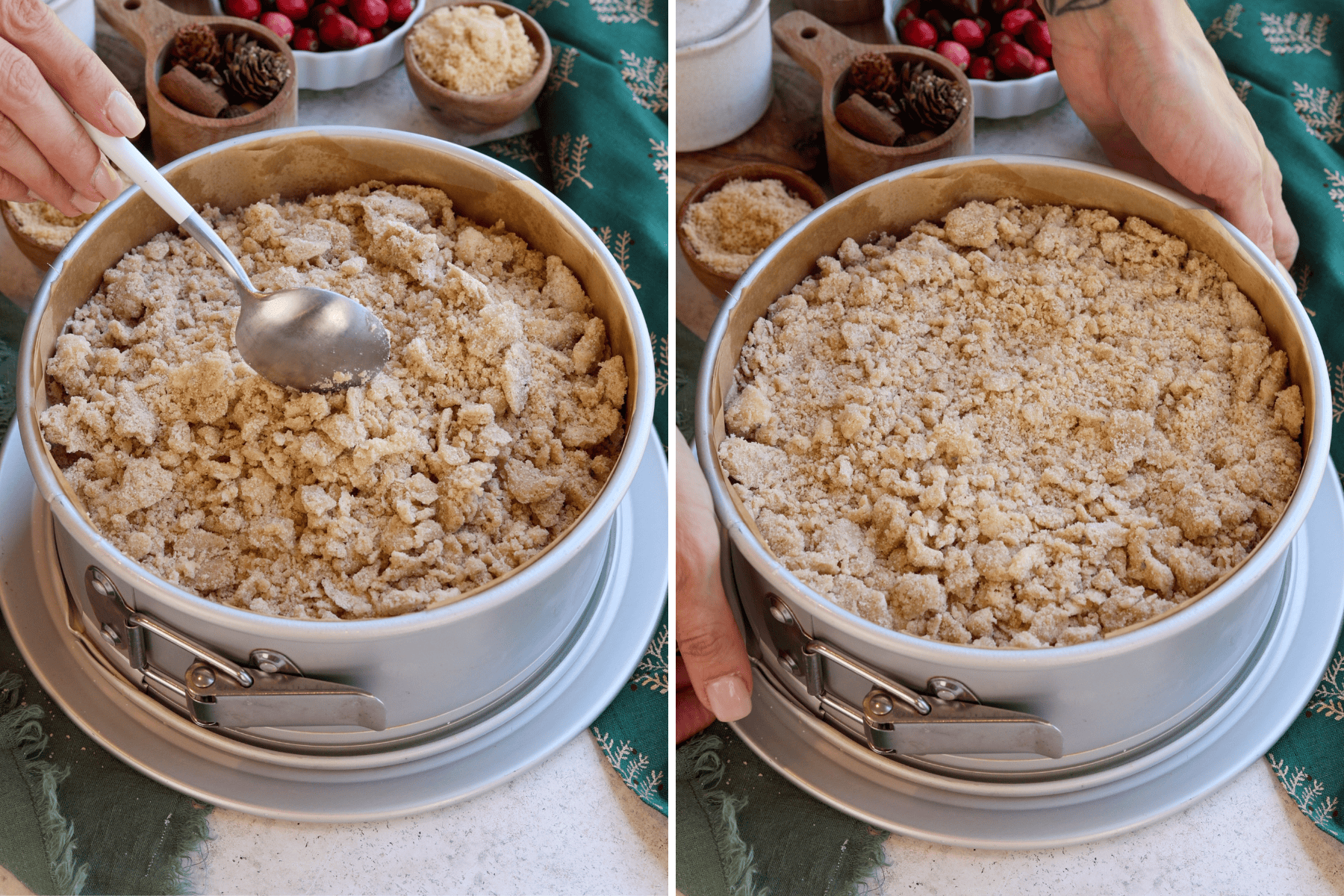 Two-step process of adding crumb topping to cranberry coffee cake in a springform pan. In the first image, a spoon is used to spread and gently press down the crumb topping over the cake batter. The second image shows the crumb layer evenly distributed and ready for baking. The pan sits on a light surface with a green holiday-themed napkin, surrounded by festive decor, including bowls of cranberries, brown sugar, and cinnamon sticks.