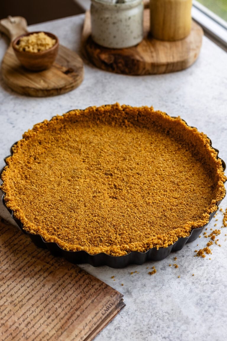 Graham cracker crust in a tart pan before baking.