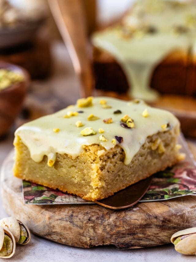 Moist pistachio blondie topped with creamy pistachio glaze and sprinkled with chopped pistachios.