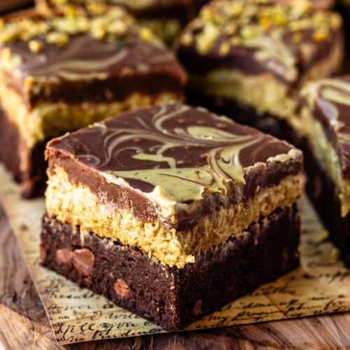 A stacked Dubai chocolate brownie with pistachio kataifi filling and chocolate ganache.