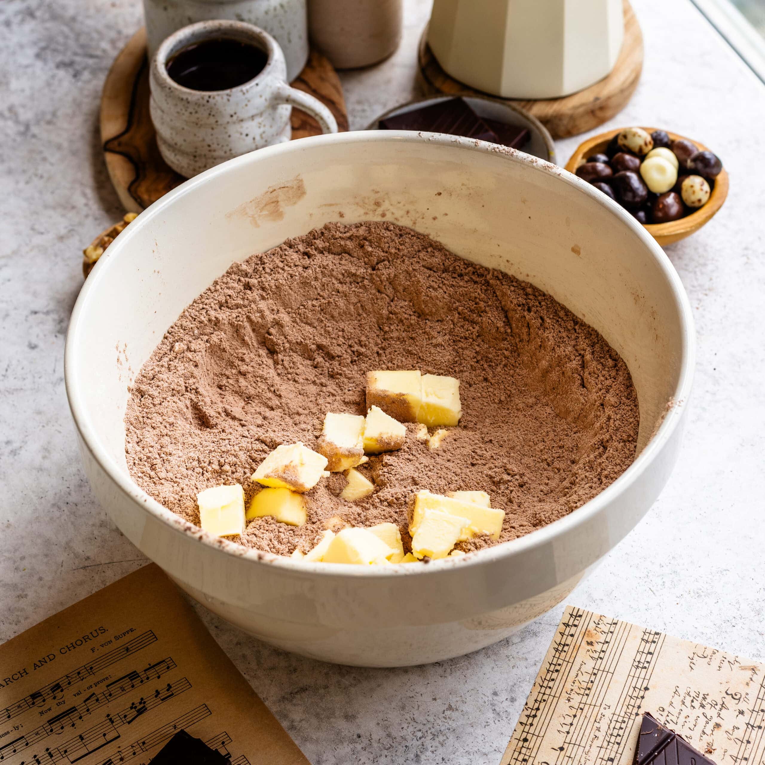 Butter being cut into the dry ingredients for espresso chocolate scones.