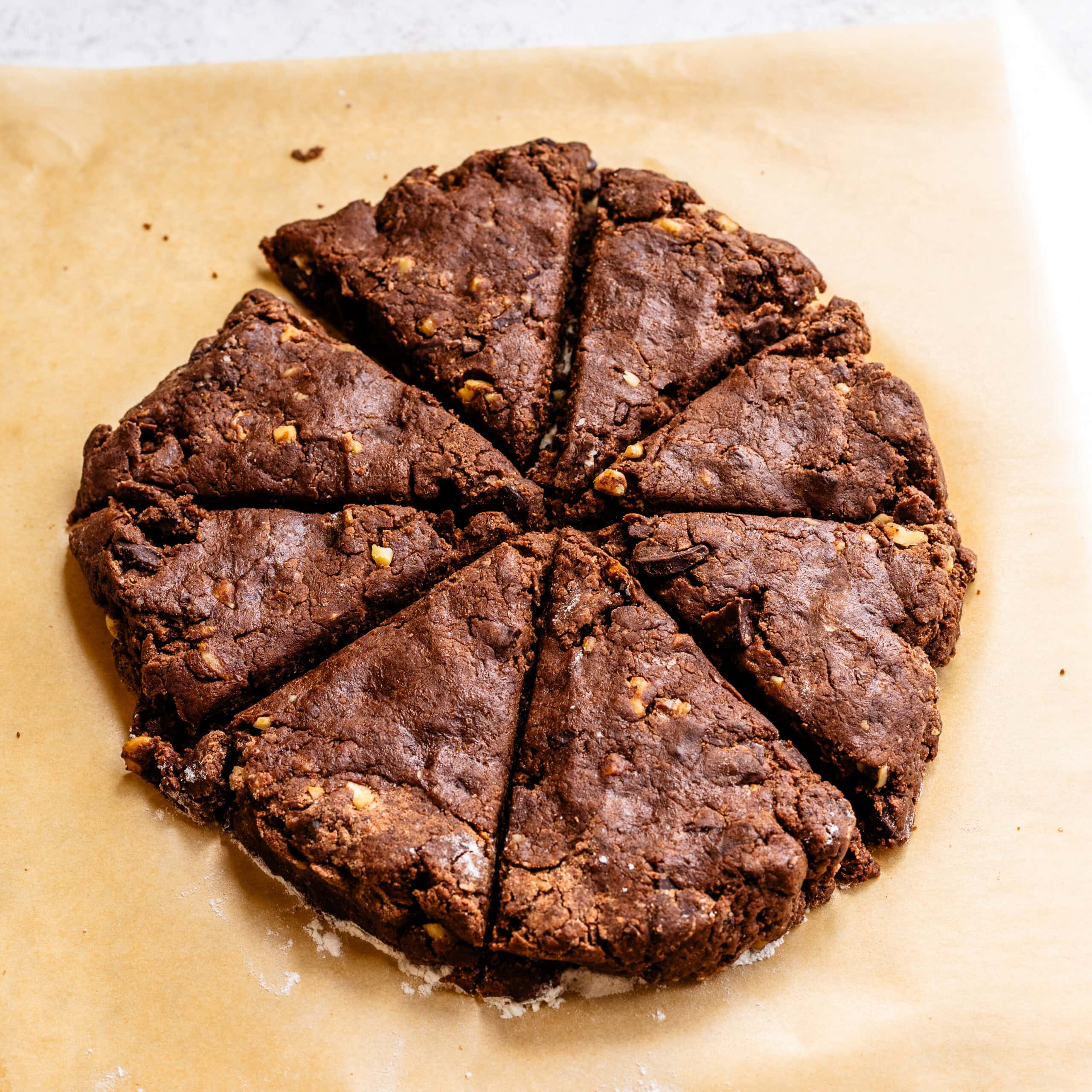 Freshly formed espresso chocolate scones. They've been cut in triangles to yield that classic shape.