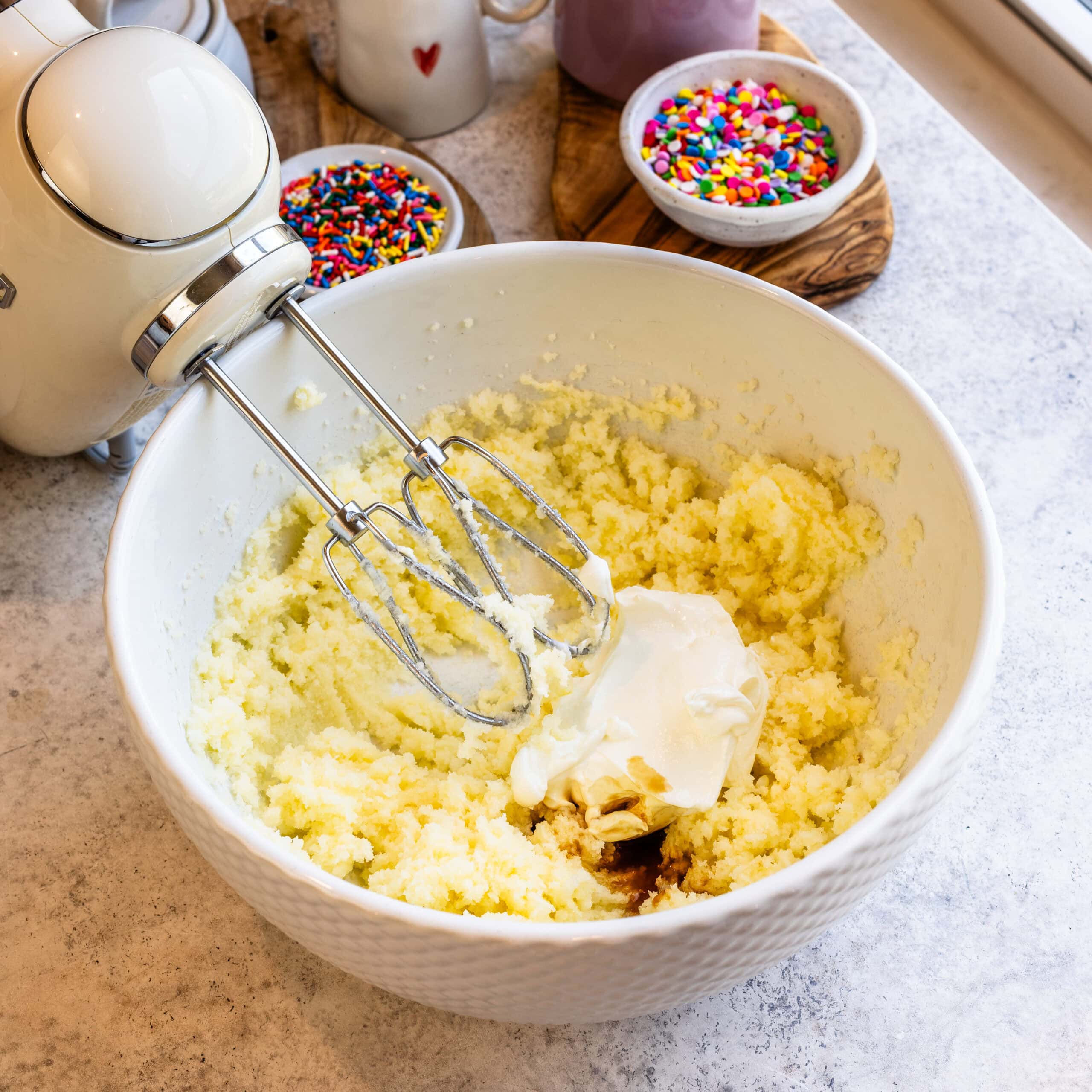 Creamy sweet potato pie filling being mixed in a white bowl.