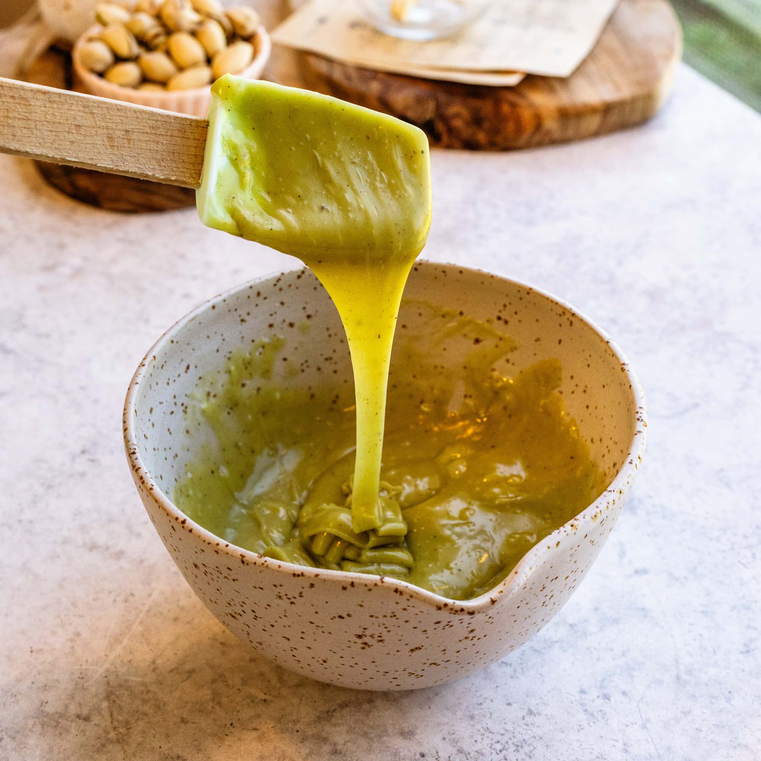 Fully mixed pistachio ganache ready for glazing atop a Pistachio Bundt Cake.