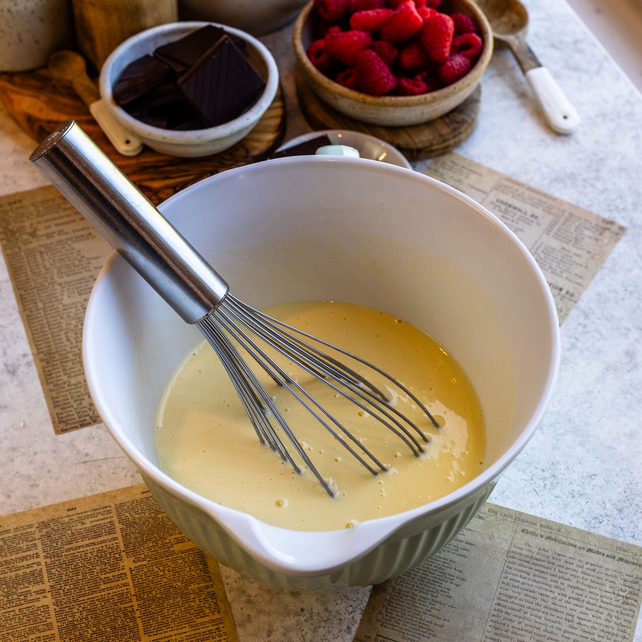 Mixing bowl with batter and whisk for pie or taco recipes.