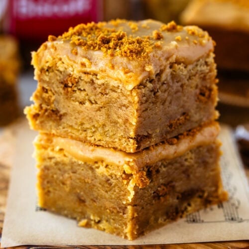 Two freshly baked Biscoff blondies stacked on top of each other with a silky Biscoff ganache.