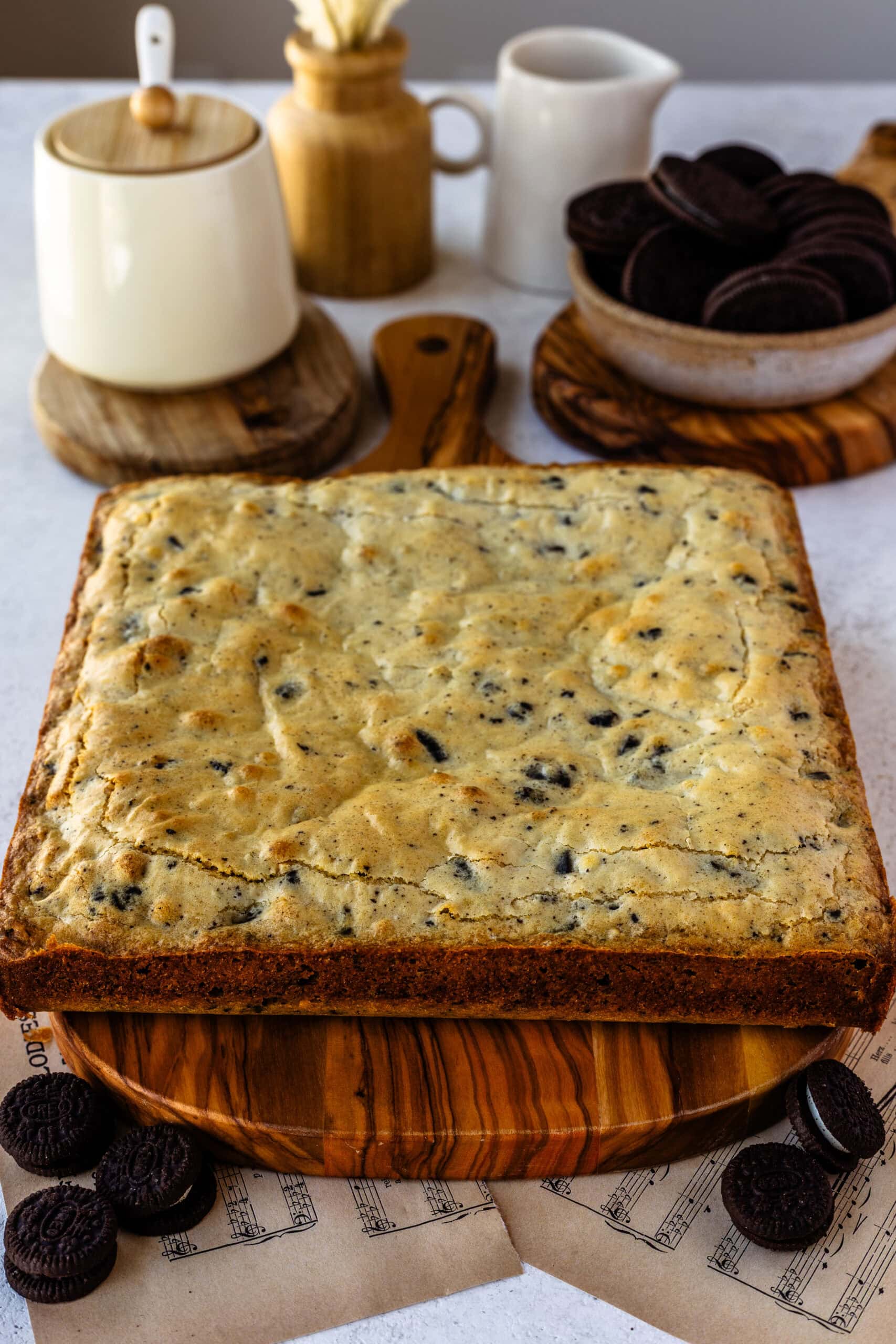 Freshly baked cookies and cream blondie bars ready to be topped with oreo ganache and sliced!