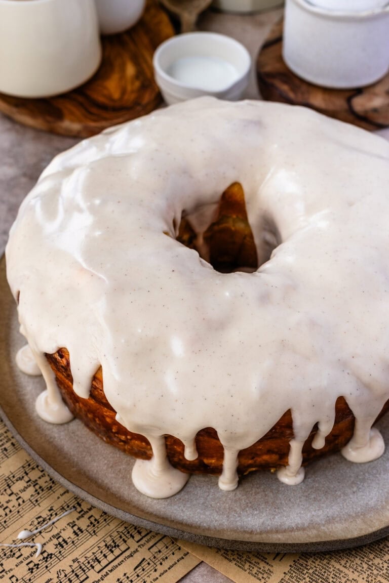 The glazed donut cake covered in a thick vanilla glaze that drips down the sides like a classic bakery-style glazed donut.