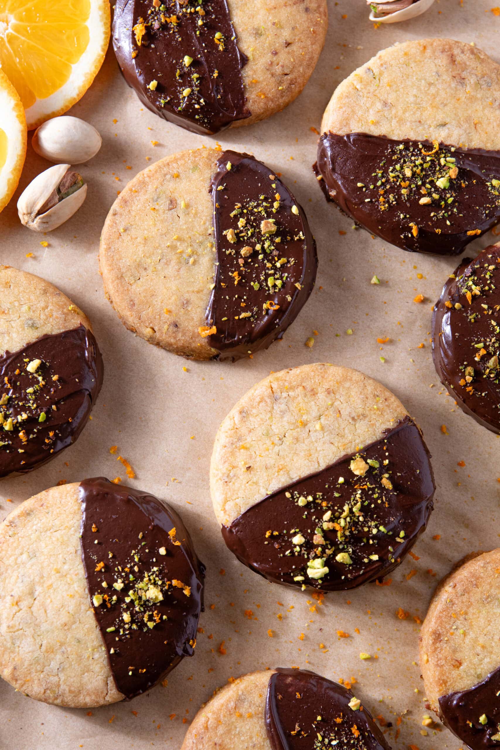 Chocolate-dipped cookies with lemon slices and pistachios for dessert.