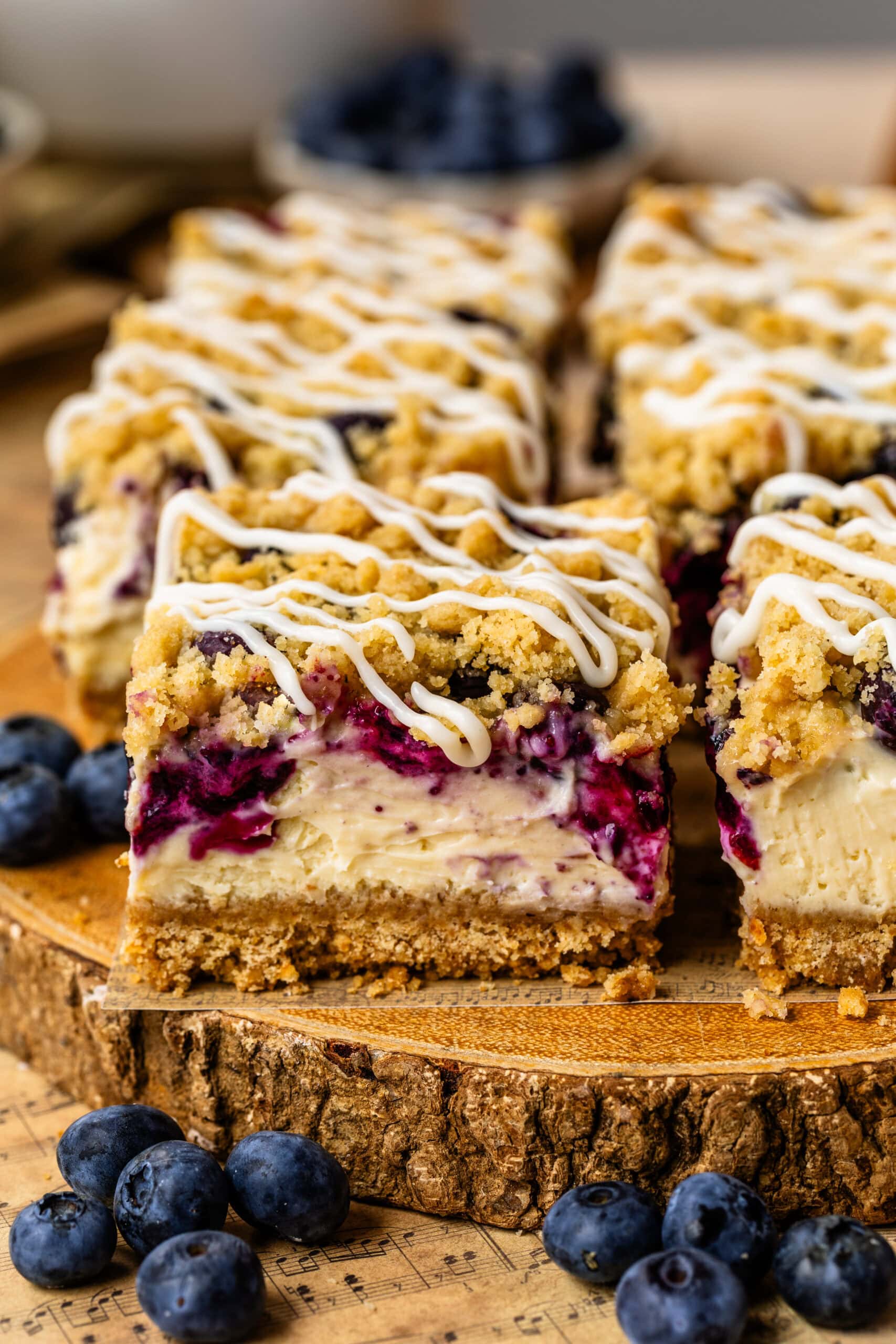 Blueberry cheesecake bars with a graham cracker crust, buttery streusel topping, and cream cheese glaze.