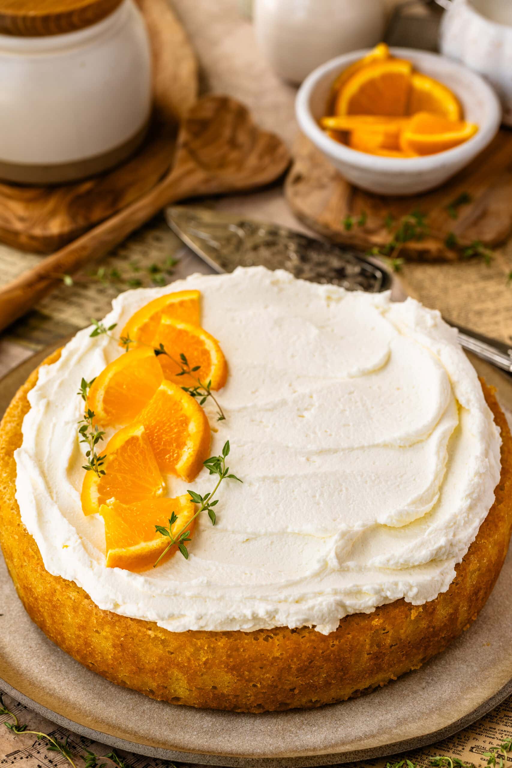 Moist olive oil cake soaked with orange syrup and topped with mascarpone whipped cream.