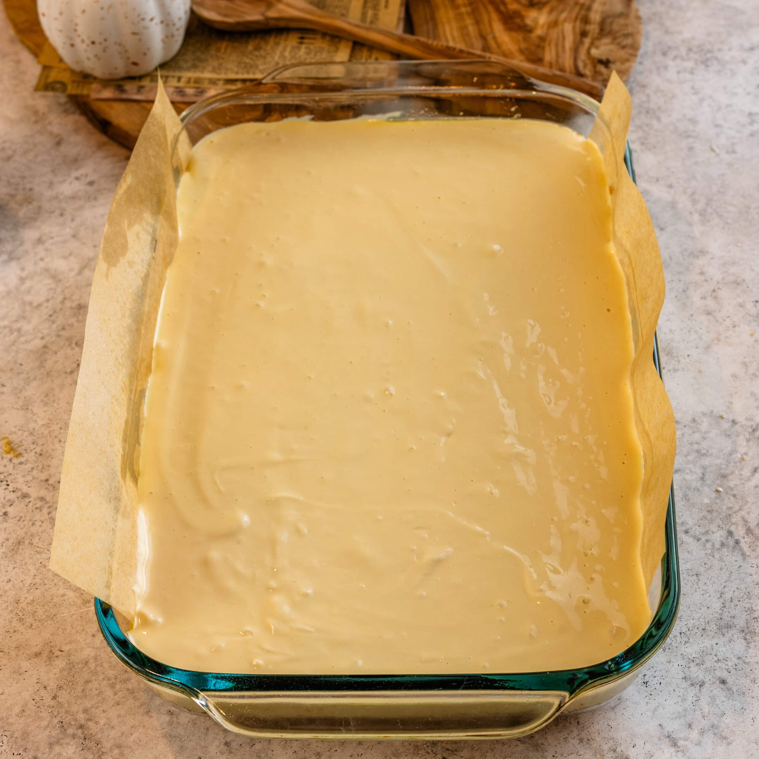 Cheesecake filling spread evenly over a prepared graham cracker crust before adding the blueberry layer.