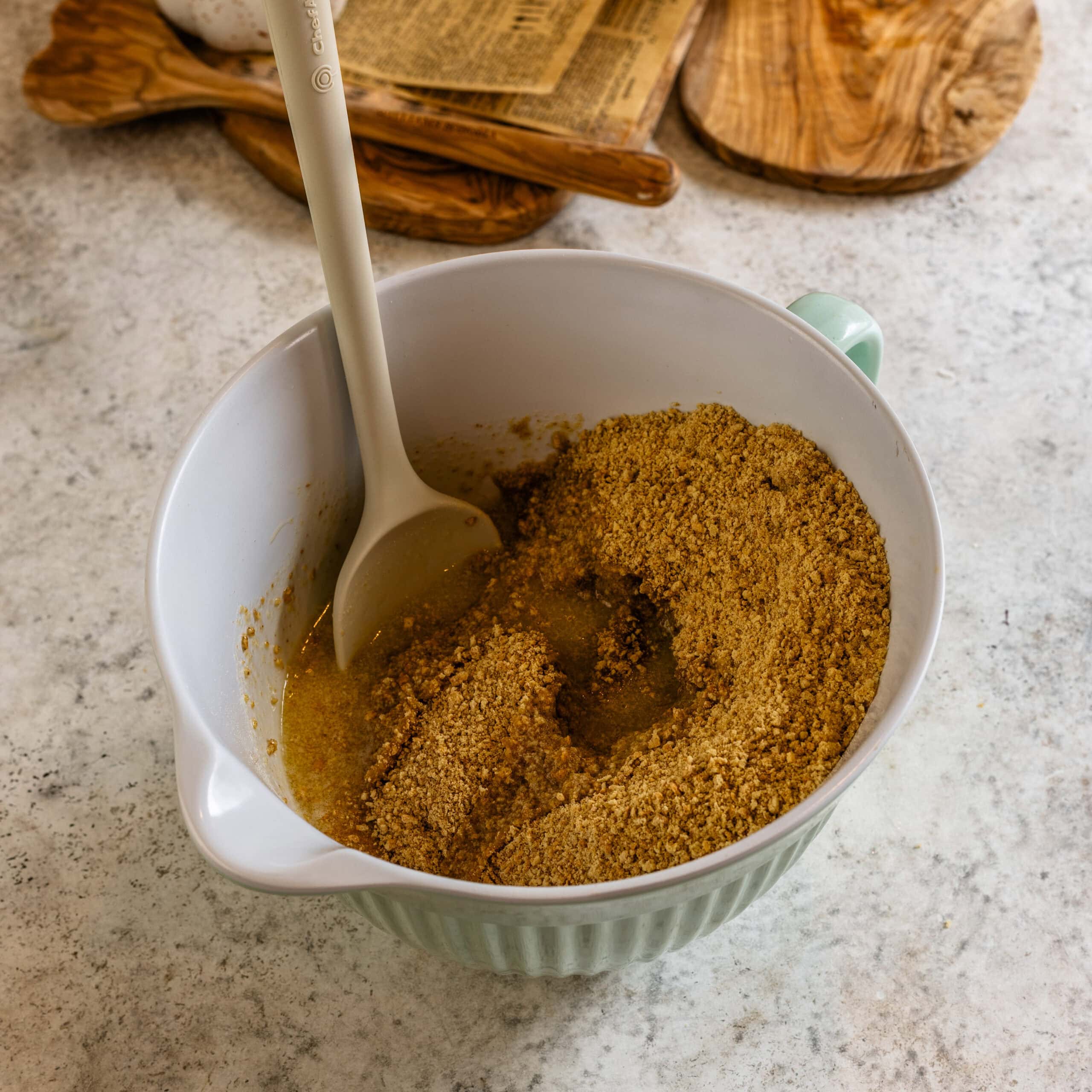 Graham cracker crust ingredients in a small bowl before mixing.
