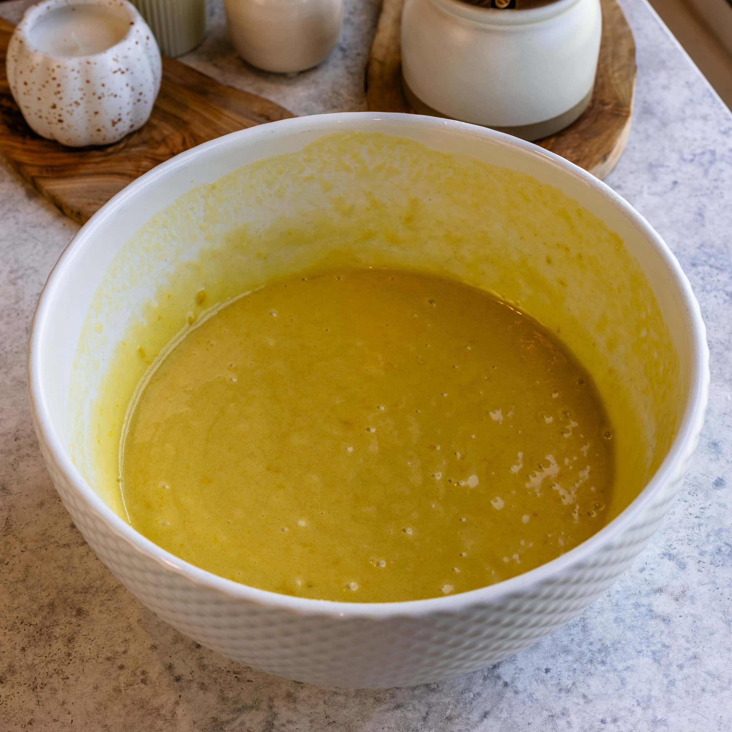 Fully mixed Olive oil cake batter in a white mixing bowl.