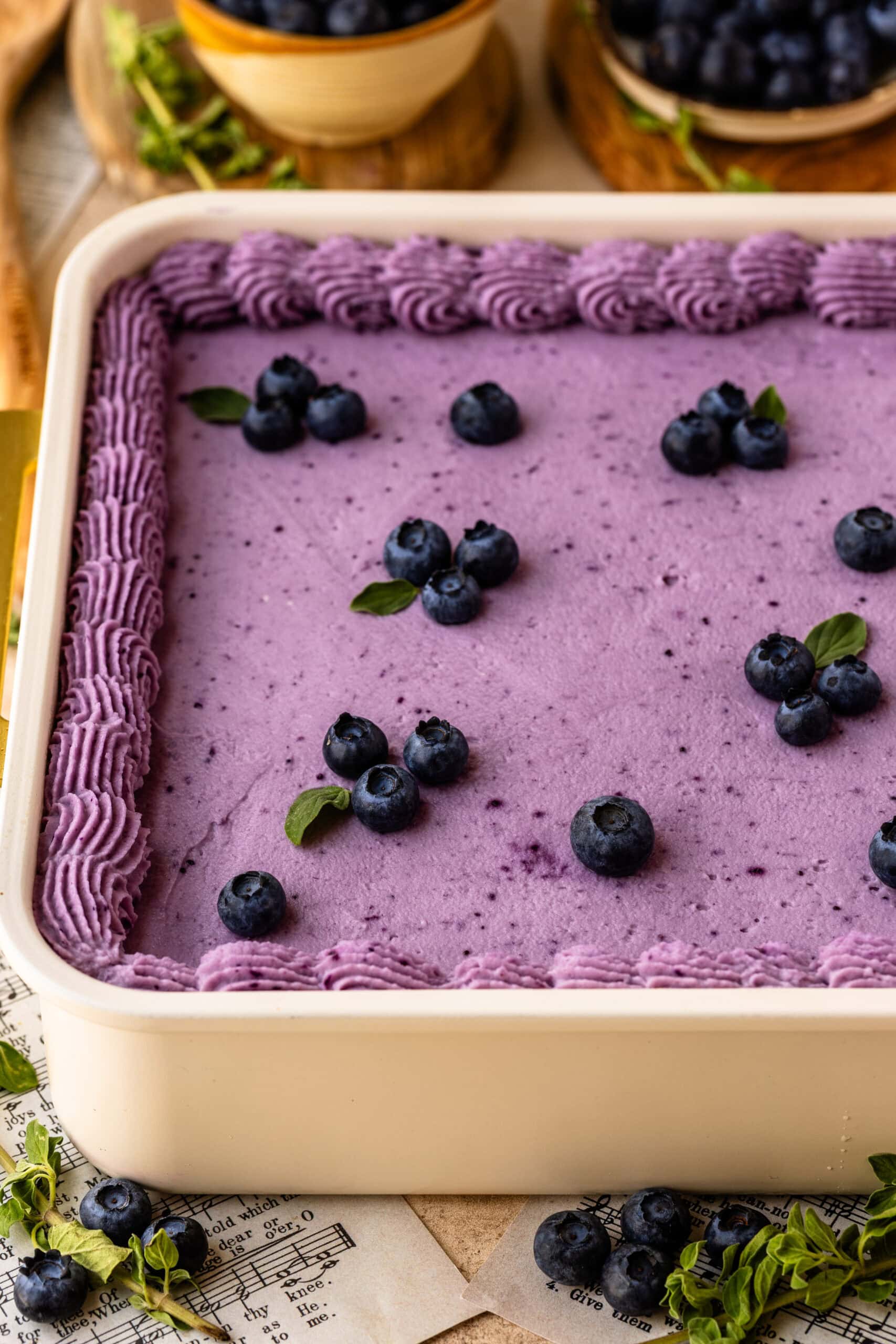 Blueberry Chantilly Sheet Cake frosted with blueberry Chantilly frosting and decorated with fresh blueberries.