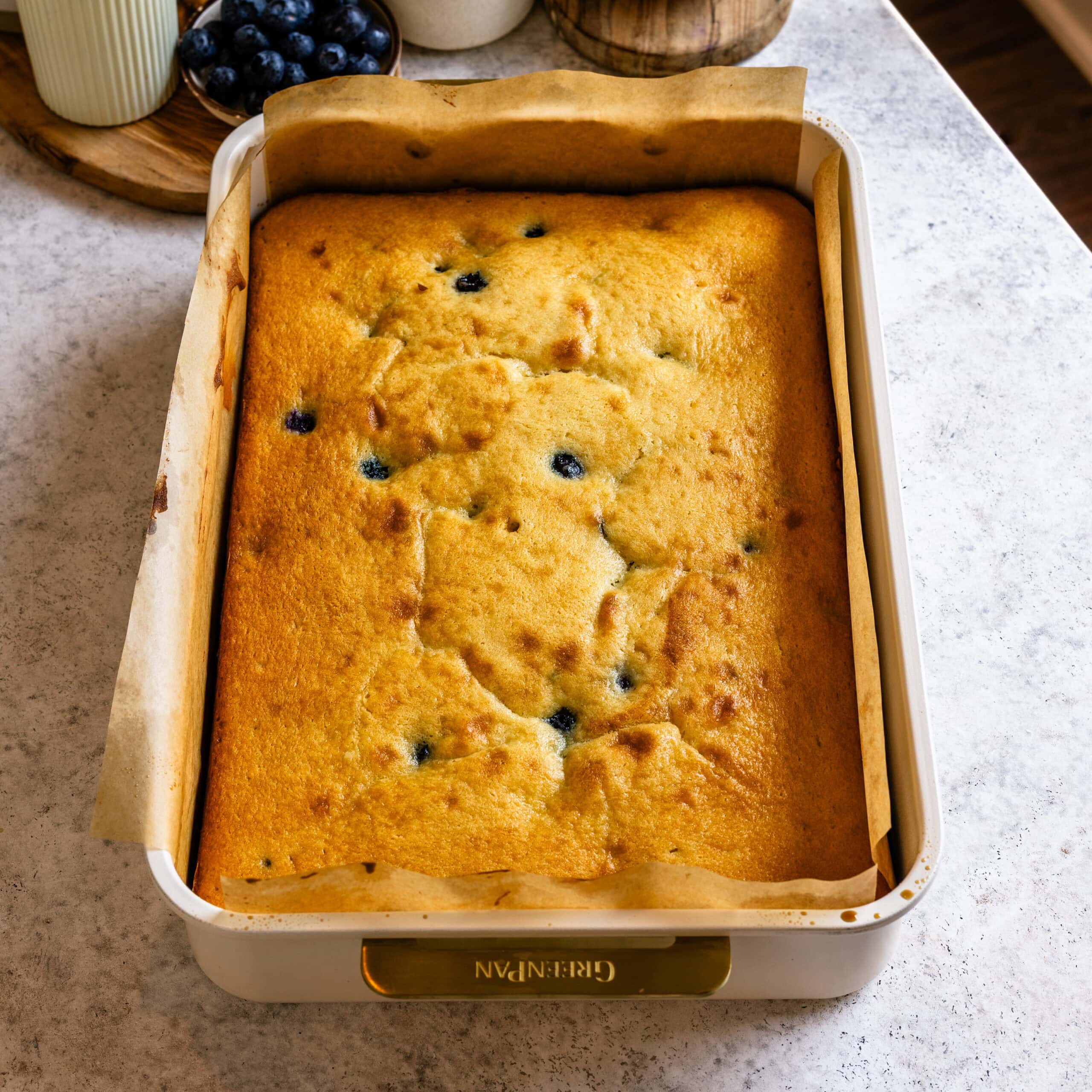 Freshly baked blueberry sheet cake in a sheet pan.