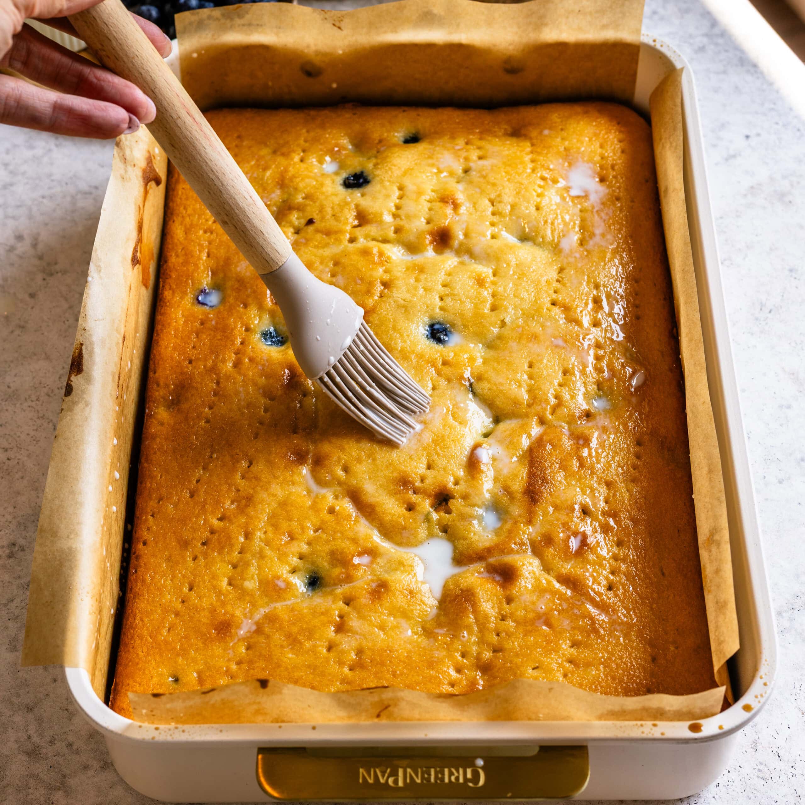 The milk soak being brushed onto the Blueberry Sheet Cake.
