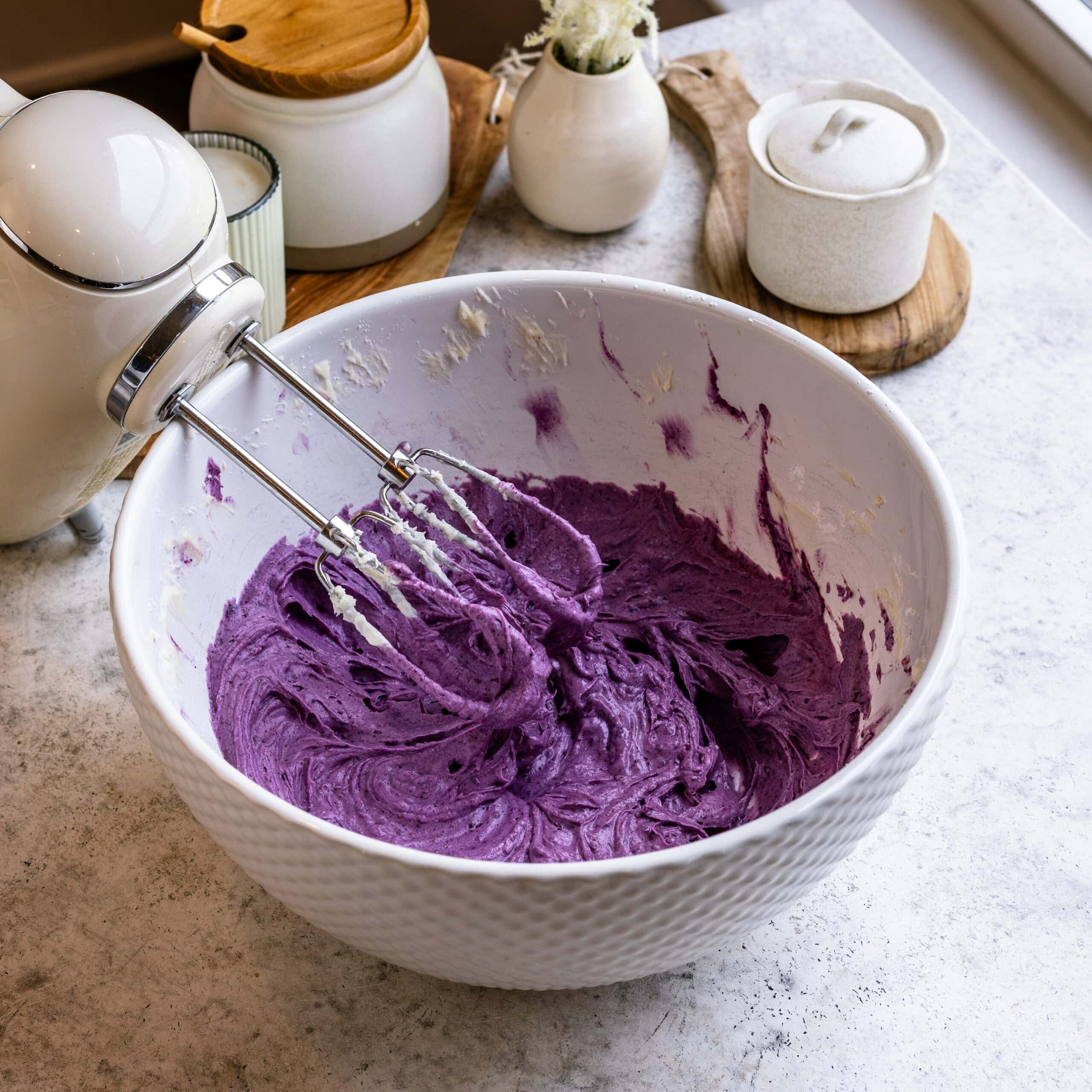 Vibrant blueberry cream cheese frosting ready to frost blueberry cake with.