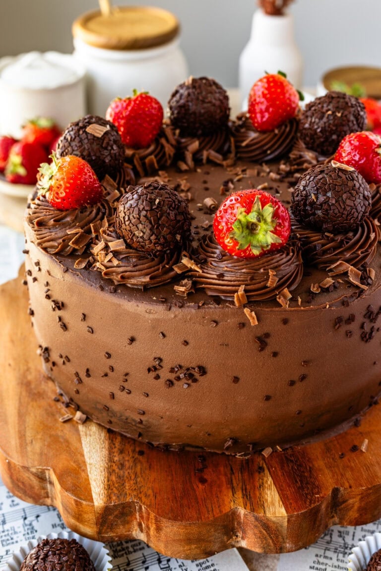 Full Chocolate Strawberry Cake frosted with Brigadeiro Ganache and decorated with fresh strawberries and brigadeiros.