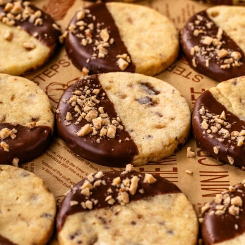 Toffee shortbread cookies dipped in milk chocolate and topped with crunchy toffee bits.