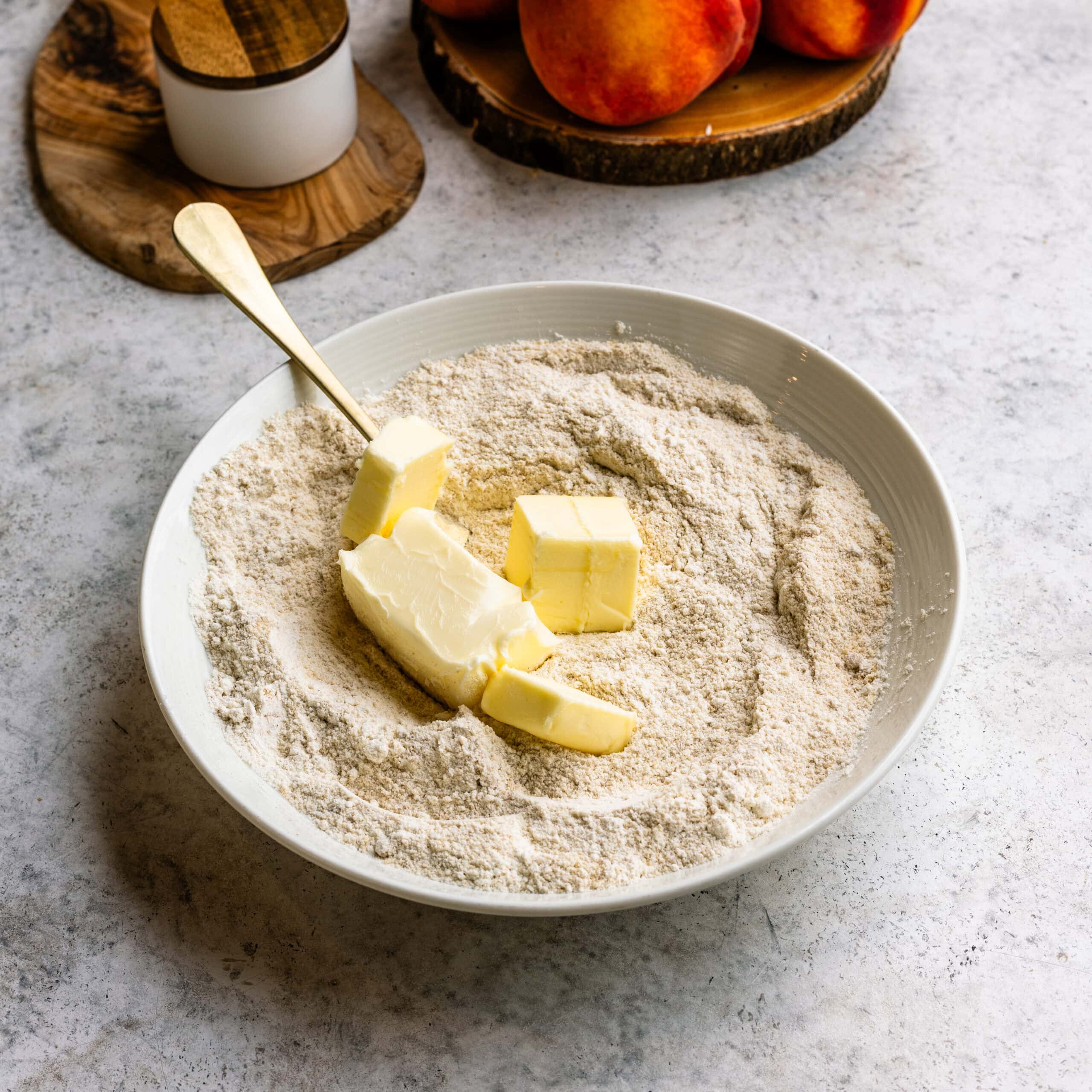 Butter being added to the crumble mixture.