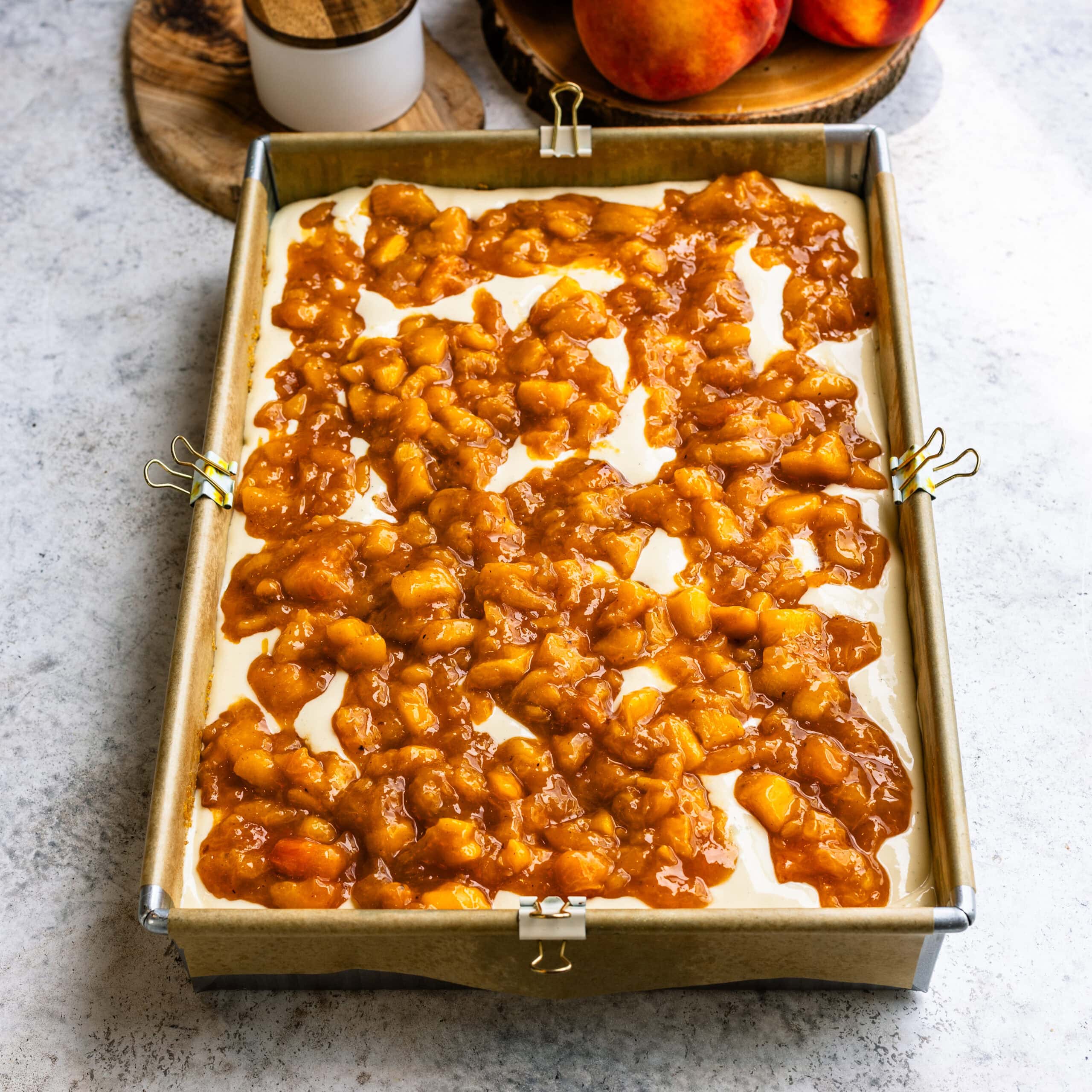A layer of peach filling added to the peach crumble cheesecake bars.