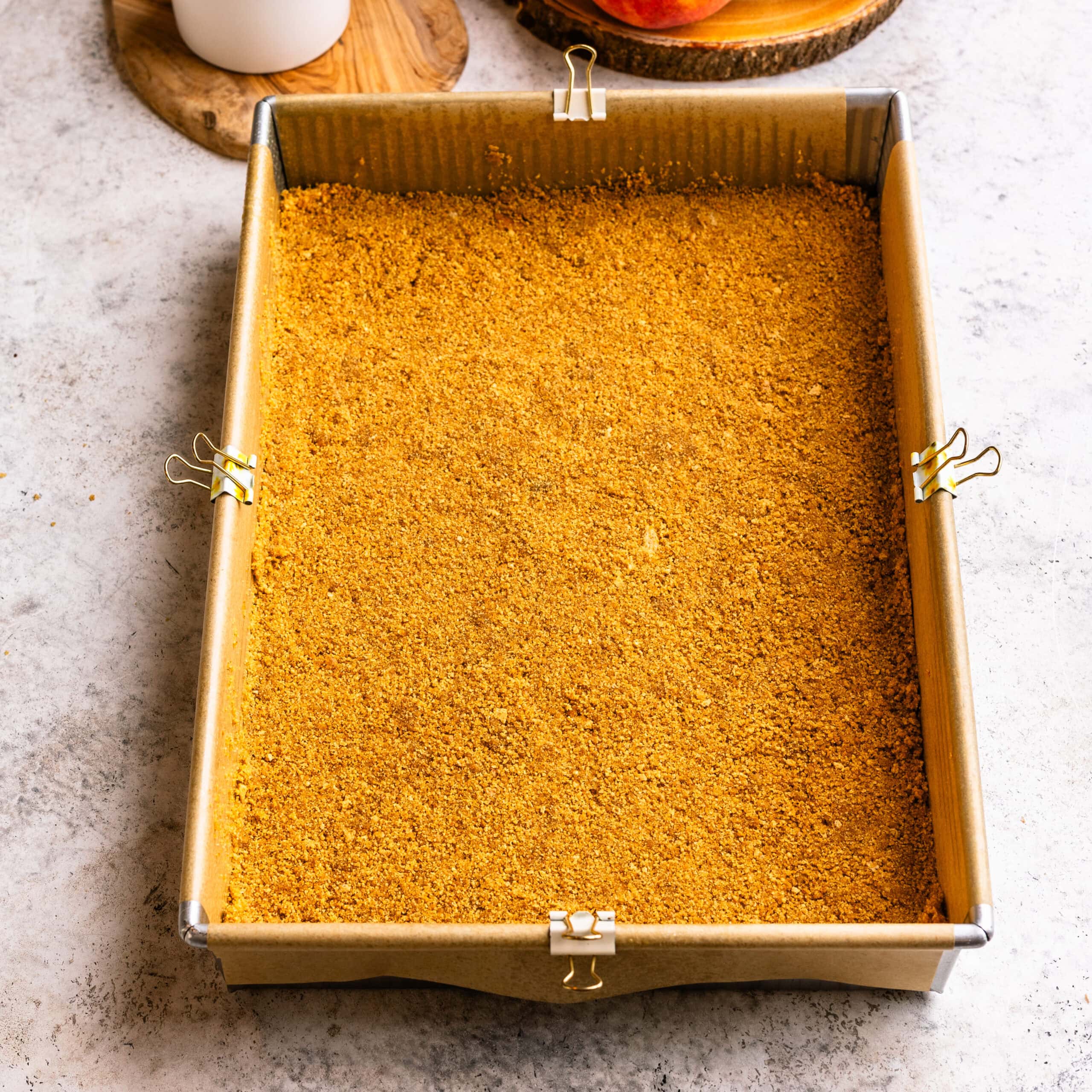 Graham cracker crust pressed into a large baking pan.
