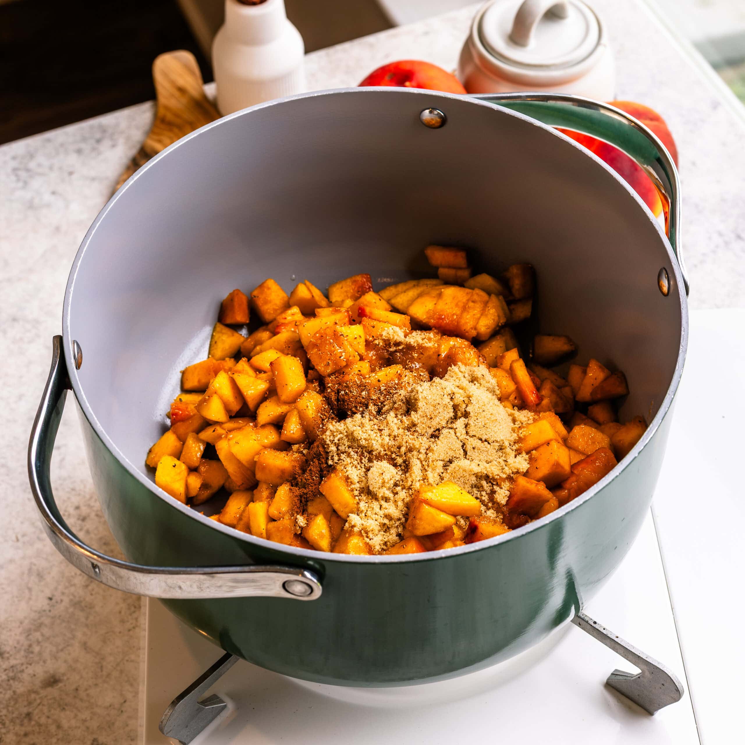 Preparing the spiced peach filling with fresh peaches, brown sugar, cinnamon, and nutmeg.