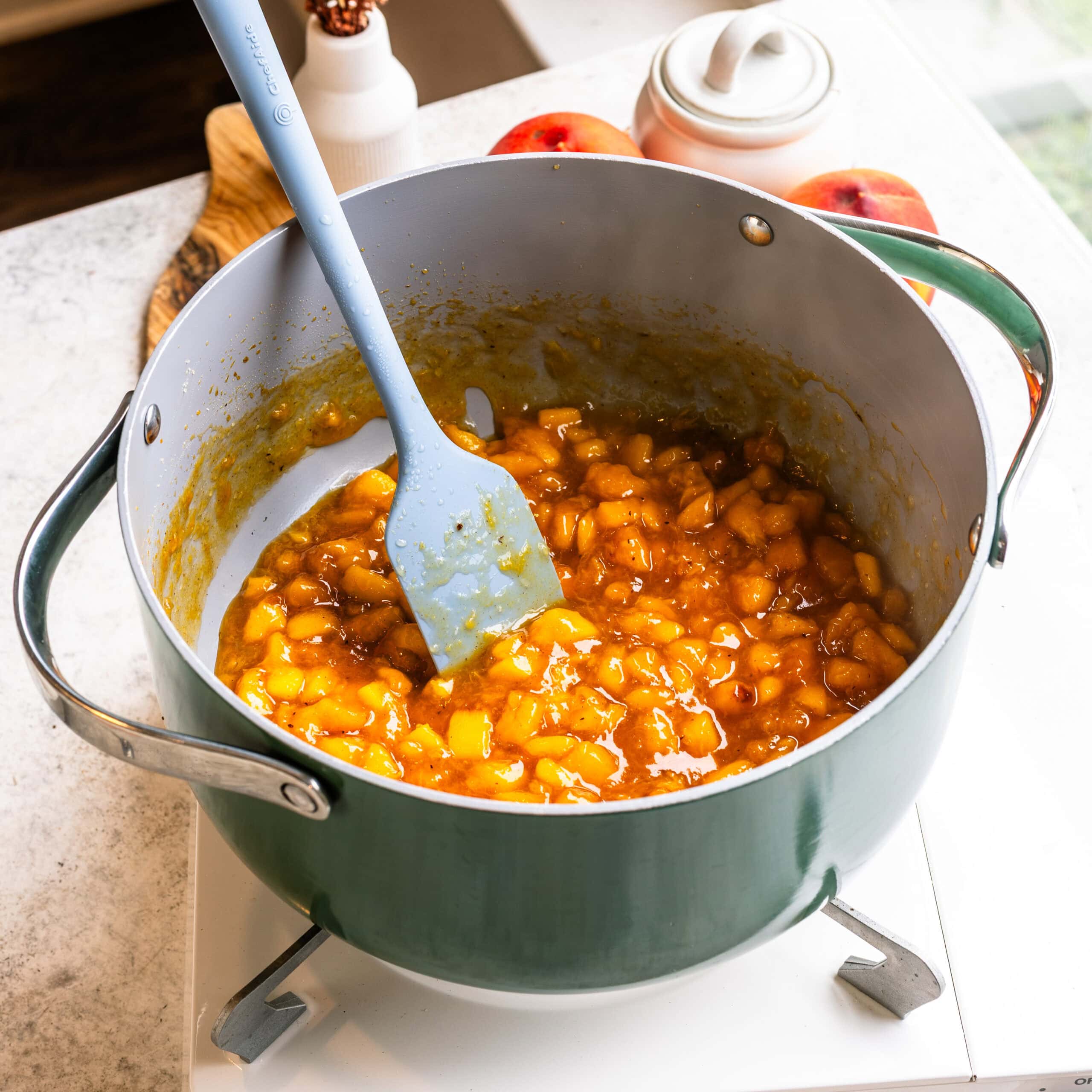 Cooked peach filling thickened with brown sugar and warm spices for Peach Crumble Cheesecake Bars.